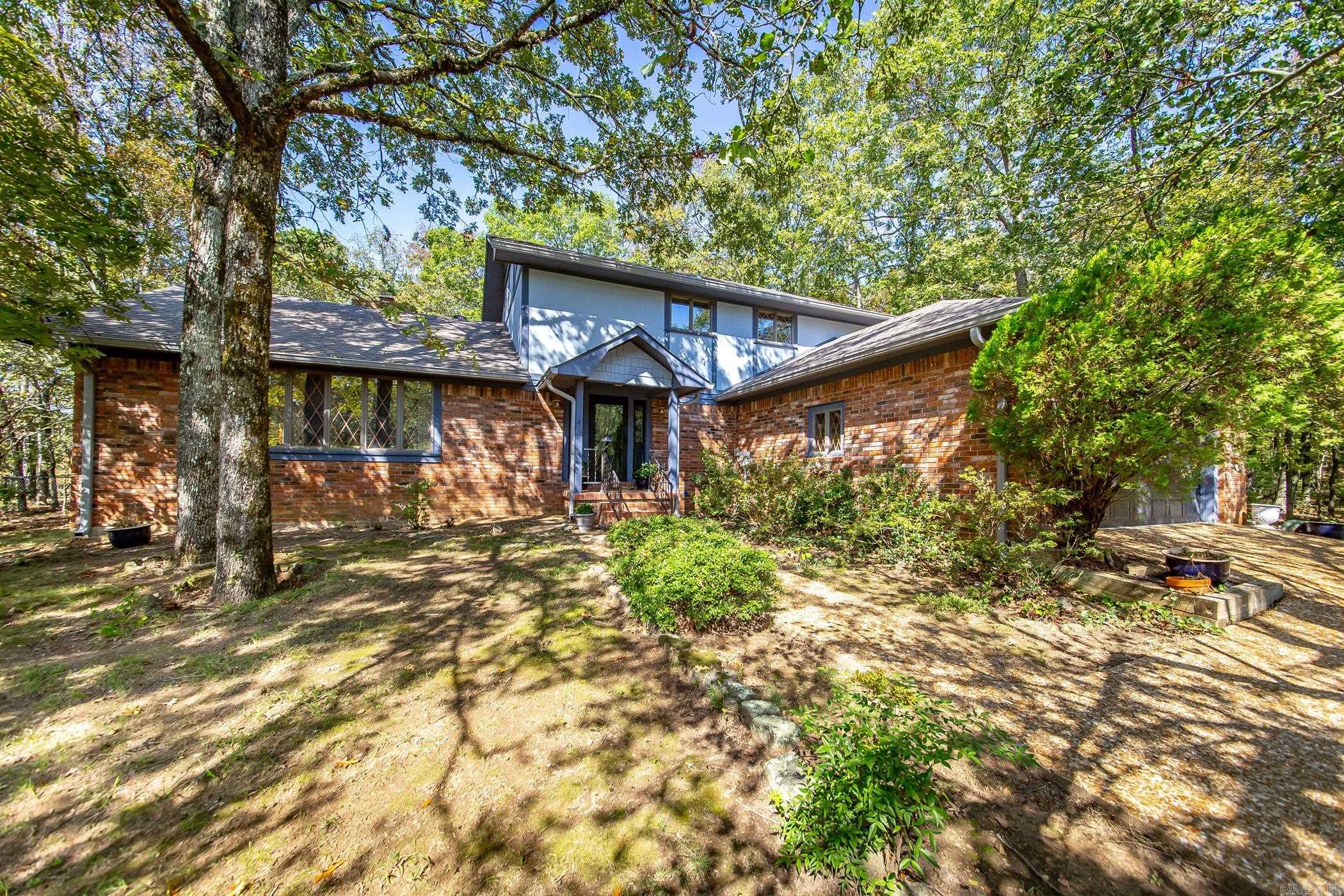 Welcome to your dream golf course home, nestled on Indian Hills Golf Course. This residence is a true gem, brimming with character & charm. Situated on 3 replatted lots, it offers privacy & tranquility while providing stunning views of the fairway. As you step inside, you'll be captivated by the new wood flooring & spacious open living area featuring a magnificent double fireplace with soaring vaulted ceilings, perfect for cozy evenings. The home is equipped with a new heating & air system, a new roof installed in 2018, & a newer water heater, ensuring modern comfort & reliability. The well-designed layout includes 6-inch walls, enhancing both energy efficiency & sound insulation. The large kitchen, pantry & oversized laundry room provide ample storage & convenience. The expansive master suite is a true retreat, complete with a private patio where you can enjoy your morning coffee or unwind after a long day. For those who love to entertain, the lovely sunroom with its charming brick flooring is an ideal spot to host friends & family. Circle Acres boat launch & Greers Ferry Lake are a short 5 min. drive away, while all the amenities of the Bay so close as well.