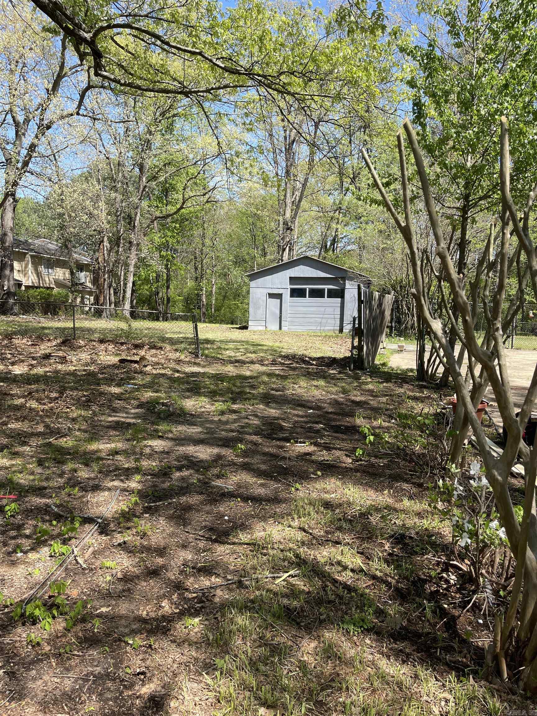 Large city lot. Beautiful trees. Garage on lot to be sold As-Is. No utility services are actively on.