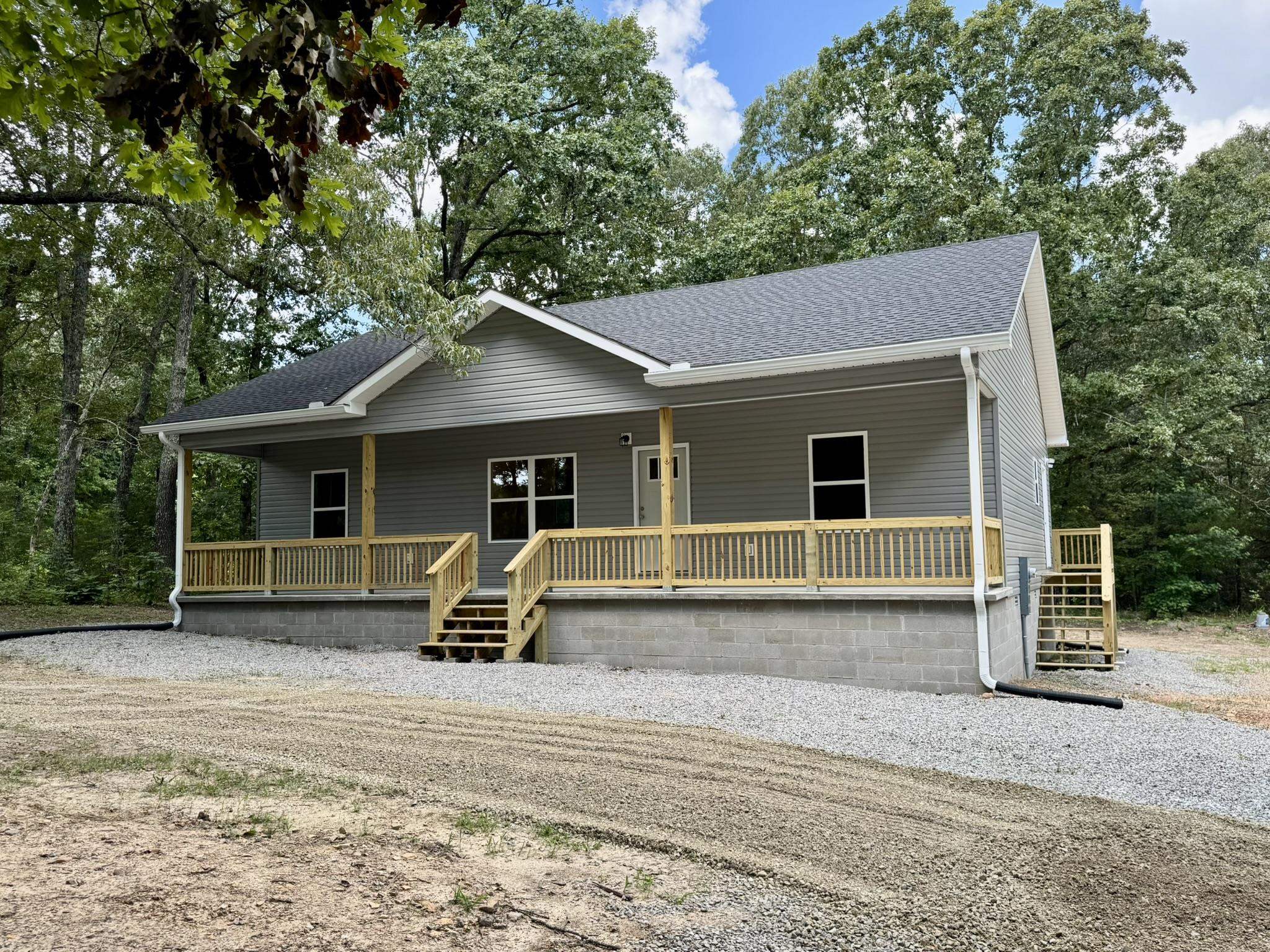 New construction tucked away on 3 peaceful, wooded acres. This modern 3-bedroom, 2-bath home offers an open floor plan with stylish finishes, 9ft ceilings throughout, and large windows that bring in natural light! Enjoy a spacious kitchen with stainless steel appliances, beautiful cabinetry, & quartz countertops. The primary suite has an attached full bathroom with a large walk-in closet. This energy-efficient home has a large concreted front and back porch, private well, circle drive, & located on a paved road! Call today to schedule a showing!