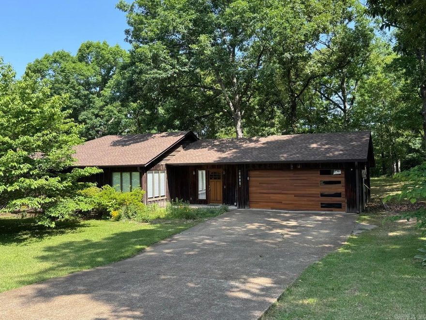 This well maintained home features bamboo flooring in most of the home, updated windows and updated baths. The living area is a great size and has large windows. The kitchen features stainless appliances accented with a beautiful walnut countertop! The renovated bathrooms are fabulously unique from the cypress walls to the Batesville limestone counter tops and custom tiled showers. The backyard has a fenced area, wonderful deck and a great pergola for entertaining, many trees, and storage closet.