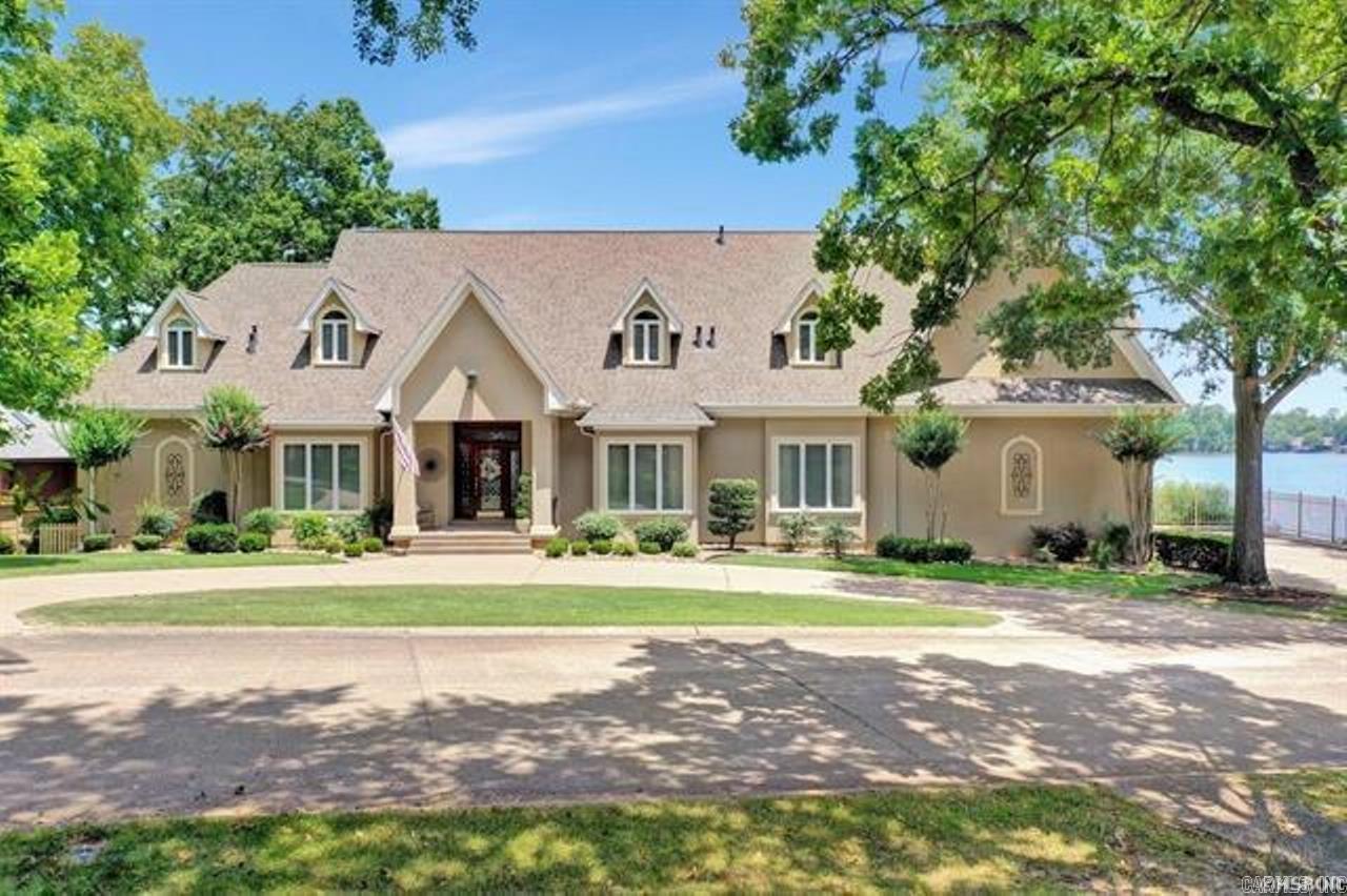 This Lake Hamilton beauty is what dreams are made of. From the moment you walk thru the door graceful elegance and a view straight out to the water will take your breath away. Hardwood floors, a master chef kitchen, large open floor plan perfect for entertaining and floor to ceiling lake views. 5 bedrooms, 3 and a 1/2 baths, 2 informal living areas, 2 kitchen areas, a master suite to die for, office, exercise and bonus space to boot! Outside features 3 patios, a lakeside hot tub and 2 stall covered dock! You deserve the very best life has to offer so check Find My Dream Home off your list - 'cause you found it! Come see for yourself why you can't wait to get packin'.