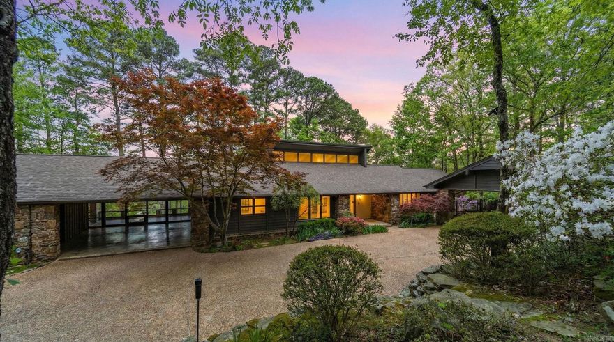 Private drive off a gated road leads to this home tucked among the trees with beautiful lake and mountain views and so much more. Vaulted great room with wood burning fireplace and walls of windows opens to multiple decks for easy indoor and outdoor living. Kitchen features granite countertops, island, and both formal and informal dining areas. Main level includes guest bedroom and hall bath along with a spacious primary suite offering a large walk-in closet and ensuite bath with dual sink vanity, soaking tub, and separate shower as well as deck leading to outdoor hot tub. Laundry room with sink and abundant cabinetry plus an all-weather sunroom connecting to the guest house. Downstairs includes two additional bedrooms with exterior access, a full bath, workshop area, under house storage and climate controlled garage. Separate guest house of approx. 898 SF, 1 bedroom, 1 bath, included in total square footage, features kitchen, laundry and large living area with fireplace and wall of windows overlooking the woods, ideal for guests or extended living. Two carports complete the setting. Come see!