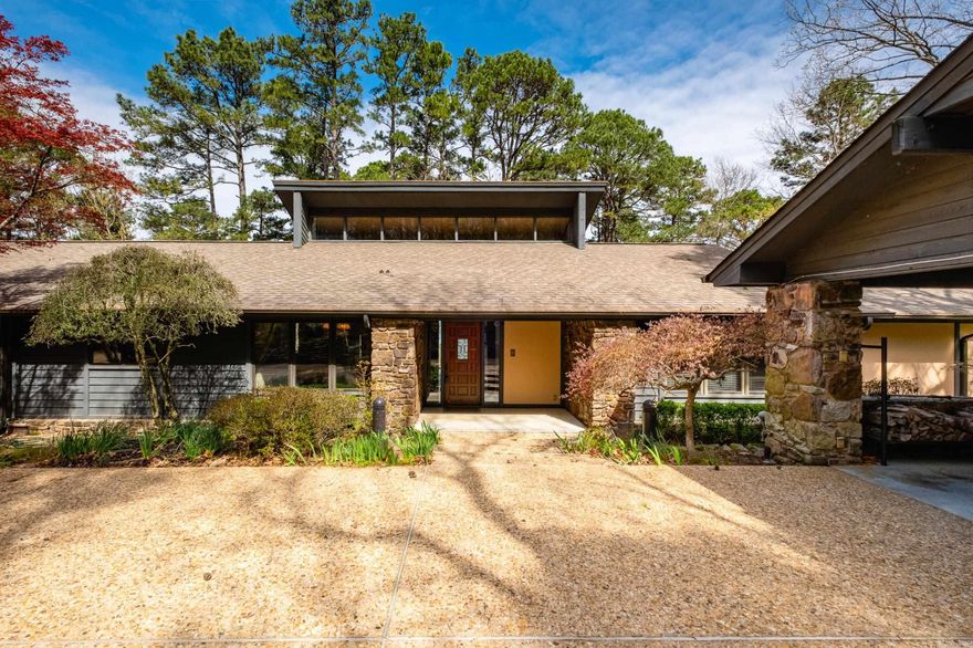 Private drive off a gated road leads to this home tucked among the trees with beautiful lake and mountain views and so much more. Vaulted great room with wood burning fireplace and walls of windows opens to multiple decks for easy indoor and outdoor living. Kitchen features granite countertops, island, and both formal and informal dining areas. Main level includes guest bedroom and hall bath along with a spacious primary suite offering a large walk-in closet and ensuite bath with dual sink vanity, soaking tub, and separate shower as well as deck leading to outdoor hot tub. Laundry room with sink and abundant cabinetry plus an all-weather sunroom connecting to the guest house. Downstairs includes two additional bedrooms with exterior access, a full bath, workshop area, under house storage and climate controlled garage. Separate guest house of approx. 898 SF, 1 bedroom, 1 bath, included in total square footage, features kitchen, laundry and large living area with fireplace and wall of windows overlooking the woods, ideal for guests or extended living. Two carports complete the setting. Come see!