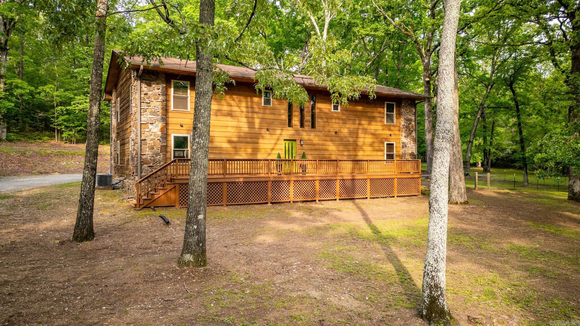 Experience quiet country living just minutes from town at this quiet oasis. Tucked behind mature trees, the stone & cedar entry welcomes you to a home with both rustic charm and modern finishes. The first floor features a bedroom w/ ensuite, a large living room w/ fireplace & bar area, laundry room w/ home gym space, and garage access. Ascend to the second level to find luxury vinyl plank flooring, a spacious kitchen with updated countertops & appliances, a cozy seating area with a fireplace and access to the upper deck, ideal for morning coffee & bird listening. Upper level includes a formal dining area, two guest beds sharing a modern bath, and a secluded primary suite. Enjoy watching deer from the front porch, or enjoying the sounds of nature & the landscaped water feature at tranquil back deck or lower patio. Additional amenities include a 24x16 shop w/ separate power, fenced in pasture for livestock w/ Run-in Shed and tack room. This property is perfect for nature enthusiasts or anyone seeking peaceful living. Come experience country tranquility with easy town access here on Marsh Rd. ****Appraisers see remarks***