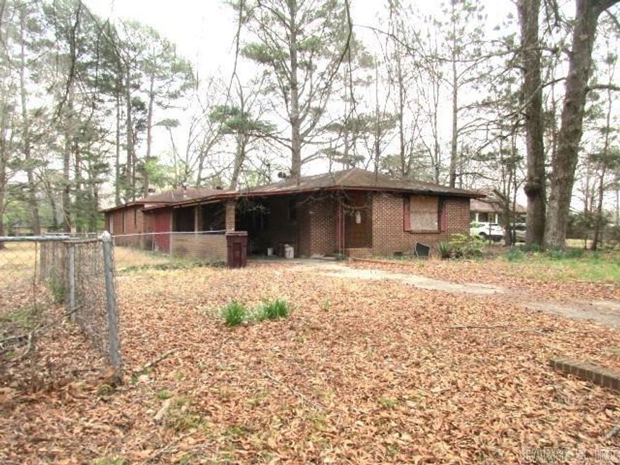 Looking for a Fixer Upper?  This is it!  This is a large corner lot, .94 acres, partially fenced with 2 homes.  The main home has 3 bedrooms and 2 baths.  It has fire damage, and some broken windows.  The second home is has 660sf and its own driveway.  Both need work.  Also, carport with small storage building.  Some missing wiring.  Call today for personal tour.  You will have to sign "Hold Harmless" form before entering home.  Property sold "AS IS".