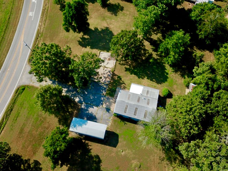 Commercial Shop w/ 4 (level) acres & Hwy 5 N and CR 11 Frontage!!! Excellent location for a business with a traffic count of 8,500 daily. 1,872 sq ft heated & insulated building. It has 11x11 office/reception with a 1/2 bath! Main part of building is 29 x 47 w/16' overhead door. Back of building has 10' sliding door and 10' roll up door, opening to a 11.5' x 15' room. Detached storage building is 16 x 24 w/ 16' roll up door, and also 19 x 24 lean-to covered storage area. RV Carport has 24 x 26 concrete pad & cover is 16 x 40 with 10' walls. MH City water, natural gas, and NEW SEPTIC in 2021. Paved drive and parking! The yard is spacious & beautiful with mature trees. Lovely options for building spots. The set-up is here to work, play & live!