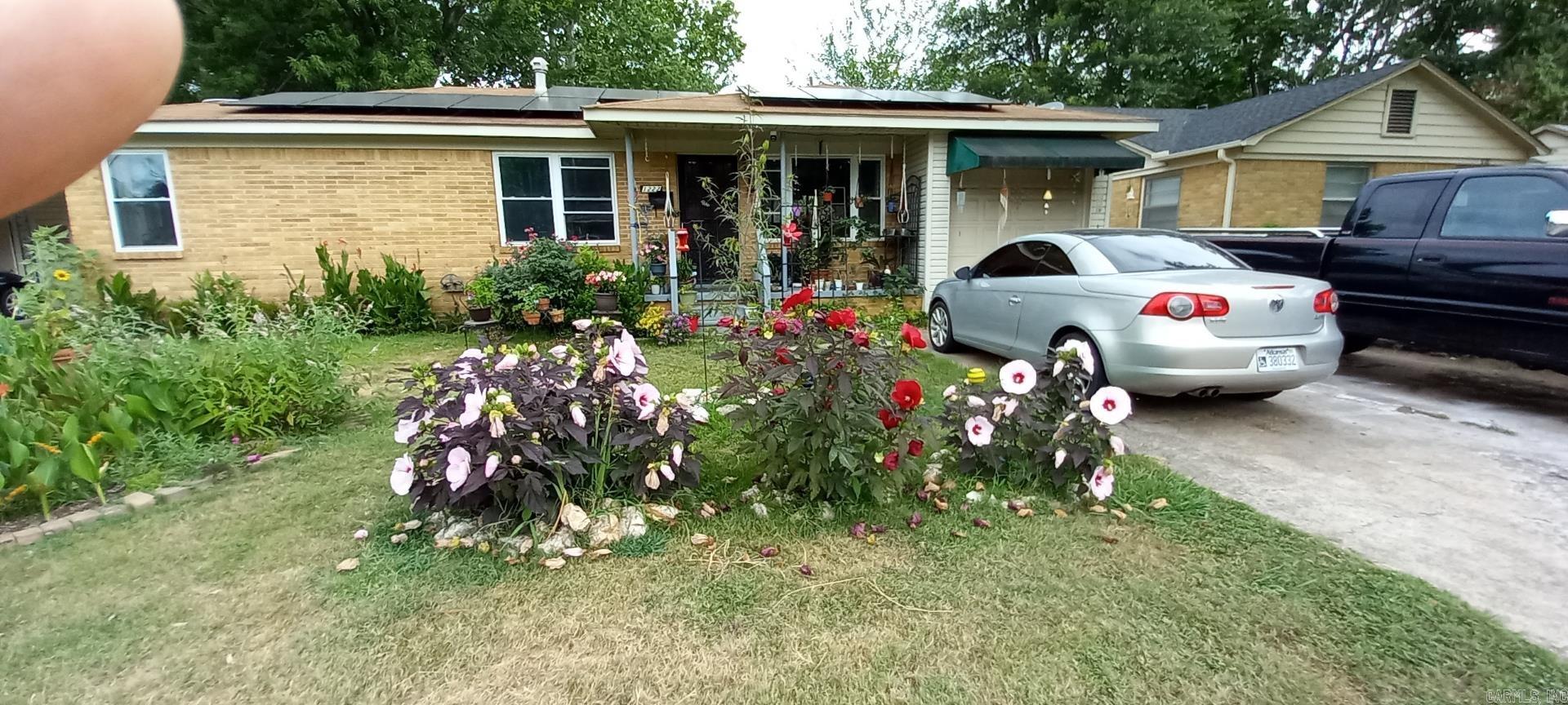 Welcome to this home that features 2 bed/2 bath and the original beautiful thin hardwood floors. You will find tile in the kitchen and bathrooms. New architectural roof in 2025, HVAC 2022 and double payne windows 2015. Nice open kitchen with panty and eat in area. Fully fenced yard with a green house and 2 sheds in backyard. House being sold AS IS condition. Agents see remarks
