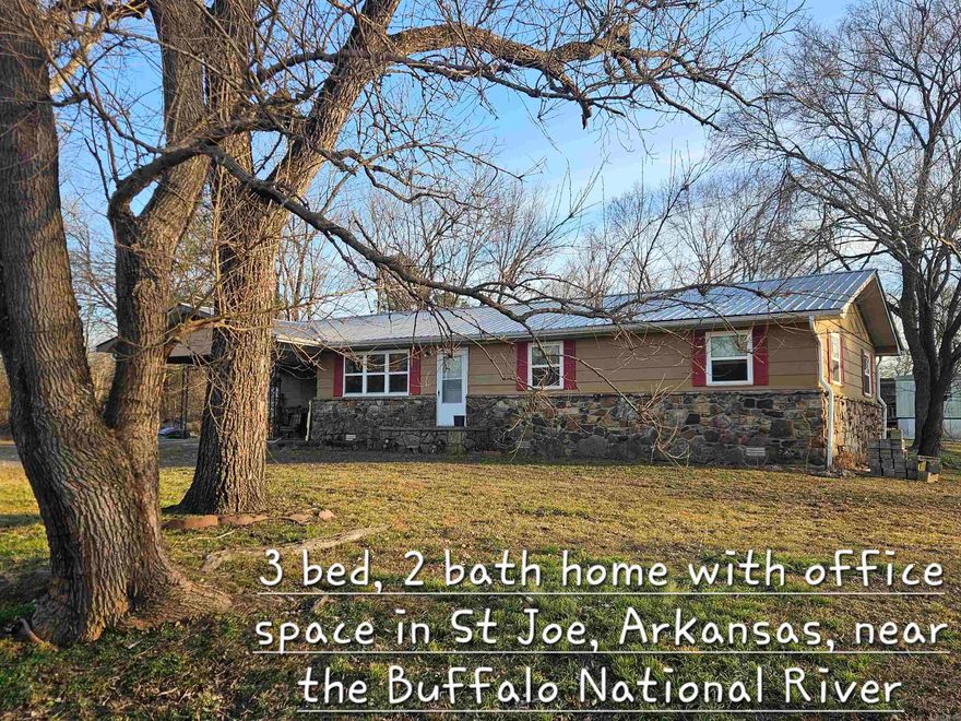 Right by the river in St. Joe, AR sits this move-in ready 3 bedroom, 2 full bath ranch with bonus office space and room to breathe. Located in an established neighborhood (no dirt roads) and just a short drive to Harrison or Branson, this one is all about convenience and possibility. Inside you’ll find a comfortable layout with space for family, guests, or working from home. Step out back to a large, pretty covered deck made for slow mornings and easy evenings. 2-car carport and storm cellar included. The property includes 1.5 lots and extra lot has septic already installed and rural water and electric available — build another home, set a trailer, or create extra income potential.Whether you’re looking for a full-time home or a nightly rental near the river, this one checks the boxes. Clean. Solid. Ready to go.
