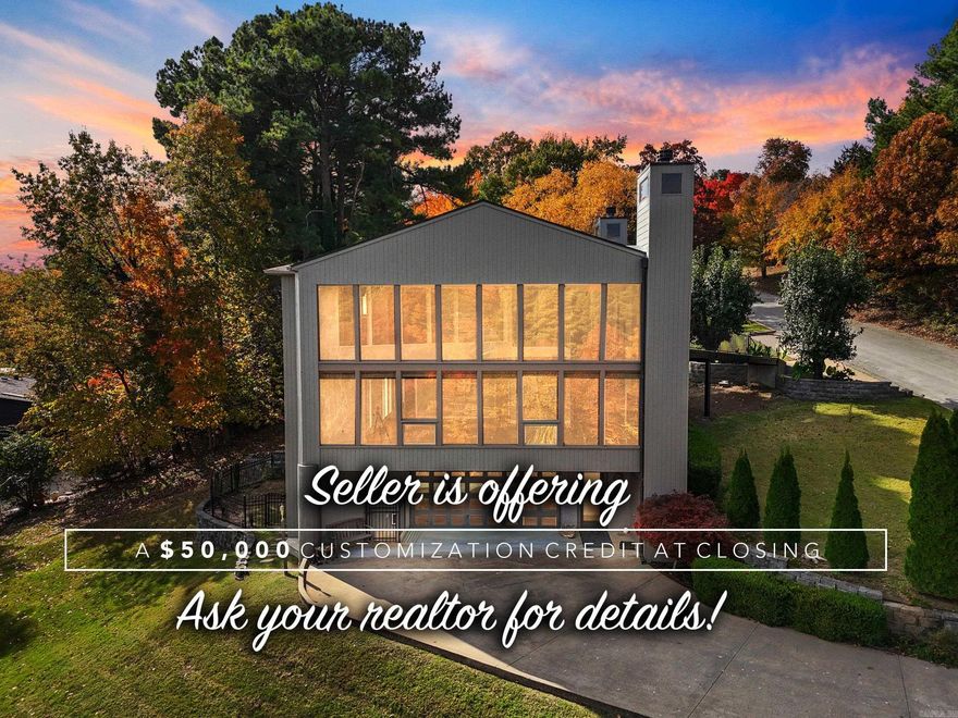 Discover the final residential design by renowned solar architect James Lambeth—a unique, welcoming home on a peaceful half-acre overlooking Lake Lucille in downtown Fayetteville. Inside are four comfortable bedrooms and two and a half well-finished baths. A spacious family room connects to a flexible game/media room—currently climate-controlled for use as a garage—with a built-in entertainment center.  Features include a maintenance free three-story elevator, home warranty, new roof, new windows, soft-water filtration, an underground electric pet fence, and a convenient laundry chute. A second-story deck with street-level access expands your outdoor living, and a home warranty adds peace of mind.  The chef-friendly kitchen centers around a modern bar, while the living room showcases a dramatic travertine fireplace and a 17-foot wall of windows with lake views. A spiral staircase, built-in media center, and cozy wood-burning fireplace add charm.  The primary suite offers a relaxing retreat with a marble bath, freestanding tub, fireplace, and double shower. A one-of-a-kind home ready for its next chapter—come see it for yourself! Schedule a showing today!