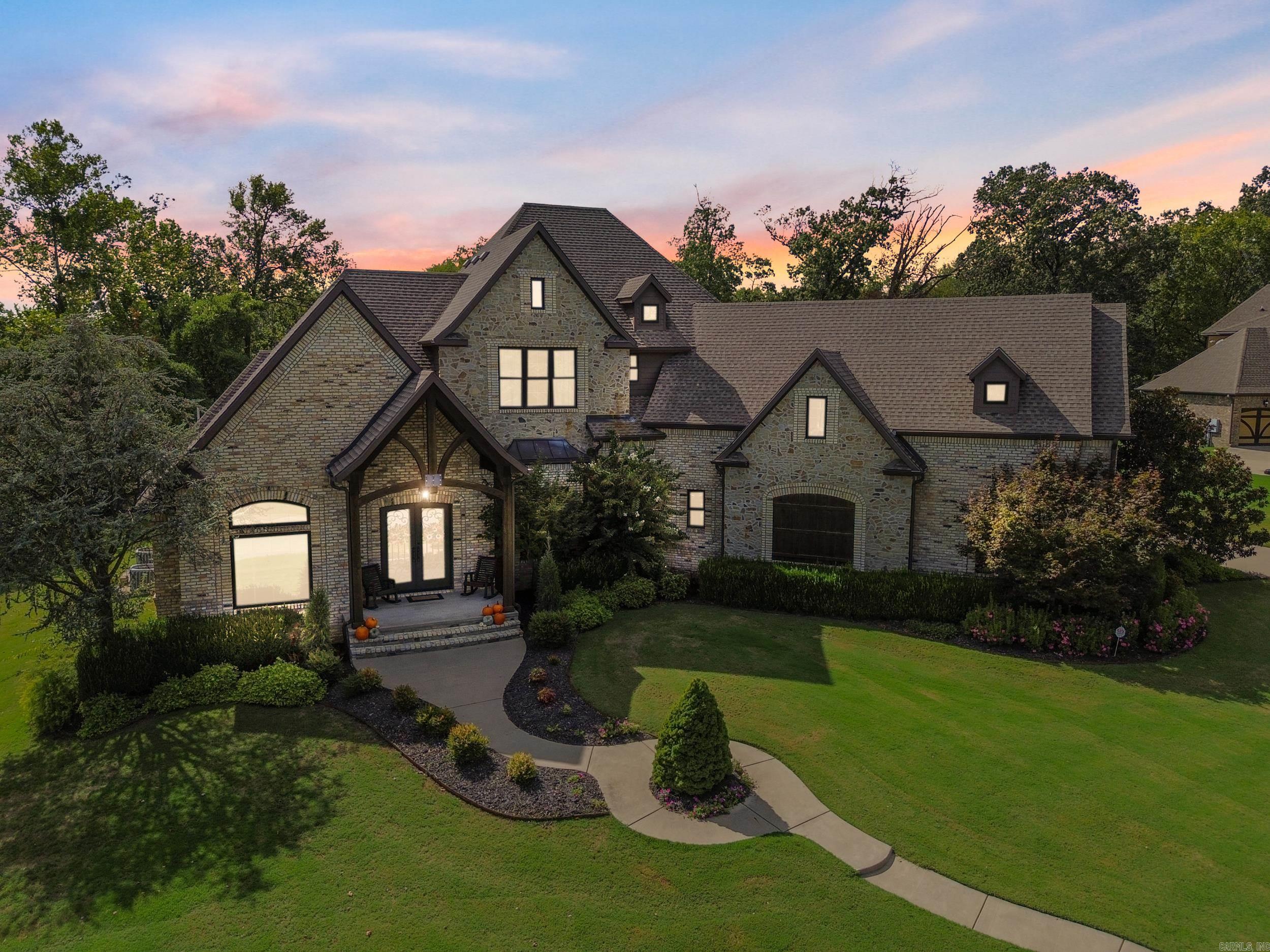 There is only one. One address. One opportunity. One moment. Welcome to your new home nestled at the top of Beau Chalet—one of Bentonville’s most exclusive gated retreats. Nestled on nearly an acre of private, wooded beauty, this custom estate offers a rare fusion of luxury, privacy, and convenience—just minutes from downtown Bentonville, Pinnacle Hills, and XNA. Inside, every detail whispers “you’ve arrived.” Vaulted, beamed ceilings. Rich custom cabinetry. Designer tile. Fresh 2025 paint and updated landscaping. Each bedroom has its own ensuite bath. A dedicated office, media room, and game room offer the perfect blend of productivity and play. Step outside to your covered patio and raised garden beds, where serenity lives in every sunset. And for peace of mind? A built-in F4-rated storm shelter keeps you safe—no matter the season. This home is not just move-in ready—it’s emotionally ready to welcome you. From morning coffee to evening gatherings, every space inspires ease, warmth, and connection. But homes like this don’t wait. There is truly nothing else like it in Bentonville. See it. Feel it. Fall in love. Then own it—before someone else steals your forever.