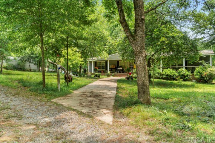Country Living blended with Tranquility & bi-city accessibility. This home sits on 2.5 acres of lush fruit trees, Iris, Lillies, grape vines, & oak trees. This kitchen has granite counter tops, great work space and plenty of storage. Sunlight throughout creates lots of natural light. Open concept and split-level floor plan meet the demands of today's checklist. Huge Front Porch to sit on & entertain. New Metal Roof in 2020, New septic in 2021. Sheds, 2 Car detached Garage, old barn, storm shelter, & storage shed. All pertinent documents for Mobile home are online, including survey, Engineering Certification & Permanently affixed to foundation. TLC for some unfinished projects but all supplies are new and paid for & convey. This seller is Motivated & has a new home under contract. Estimated sq ft., feel free to measure. PLEASE SEE AGENT REMARKS AND/OR CALL LISTING AGENT PRIOR TO SHOWING.