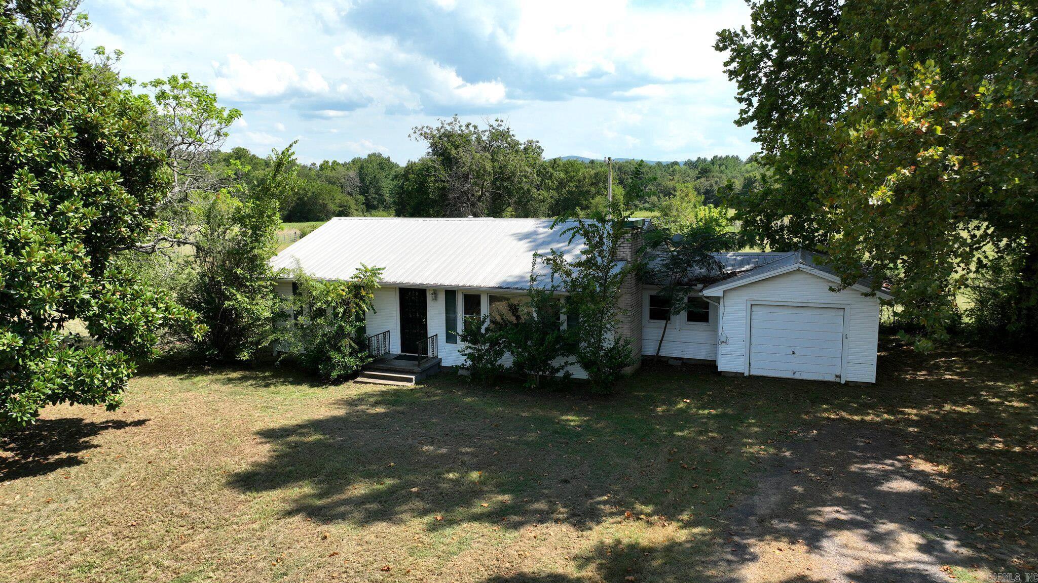 Discover the charm of country living with this adorable, remodeled older home on 35.43 beautiful acres near Waldron, Arkansas! This spotless 2-bedroom, 1-bath home boasts real wood floors in most rooms, and thoughtful updates that preserve its character while adding modern comfort. A seasonal creek winds through the property, adding to its serene appeal. Perfect for a hobby farm or small livestock, the land features a 30x30 detached garage/shop and a massive 45x100 Quonset barn ideal for hay, equipment, or storage. Enjoy easy access with highway frontage and endless outdoor opportunities nearby, including the Ouachita National Forest. Whether you’re looking for a peaceful homestead, a weekend retreat, or a place to live the simple country life, this property is cute as a bug and ready for you to call home! Well on property. Fireplace in living room is non functional. Capped and possibly filled in, decorative only. Head gate and sqeeze shoot do not convey.