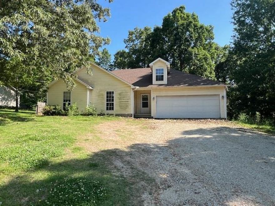 Tucked away in a peaceful setting surrounded by mature trees, this 3 bedroom, 2 bathroom home offers the perfect blend of privacy and convenience. Whether you’re a first-time homebuyer or looking to downsize, this home could qualify for zero-down loan options —making your move easier than ever! Spacious Living Area – Enjoy the open layout with gorgeous hardwood floors and a ceiling fan centerpiece. Roomy Kitchen – Natural light pours in through large windows, highlighting the classic wood cabinets and tile flooring. Three Comfortable Bedrooms – Plenty of space for family, guests, or a home office. Two Full Bathrooms – Designed for function and comfort. 2-Car Garage – Plenty of room for parking and storage. Secluded Lot – Surrounded by nature with no rear neighbors, giving you the peaceful lifestyle you deserve. Located just minutes from town amenities, but you’ll feel like you’re miles away from the hustle and bustle.