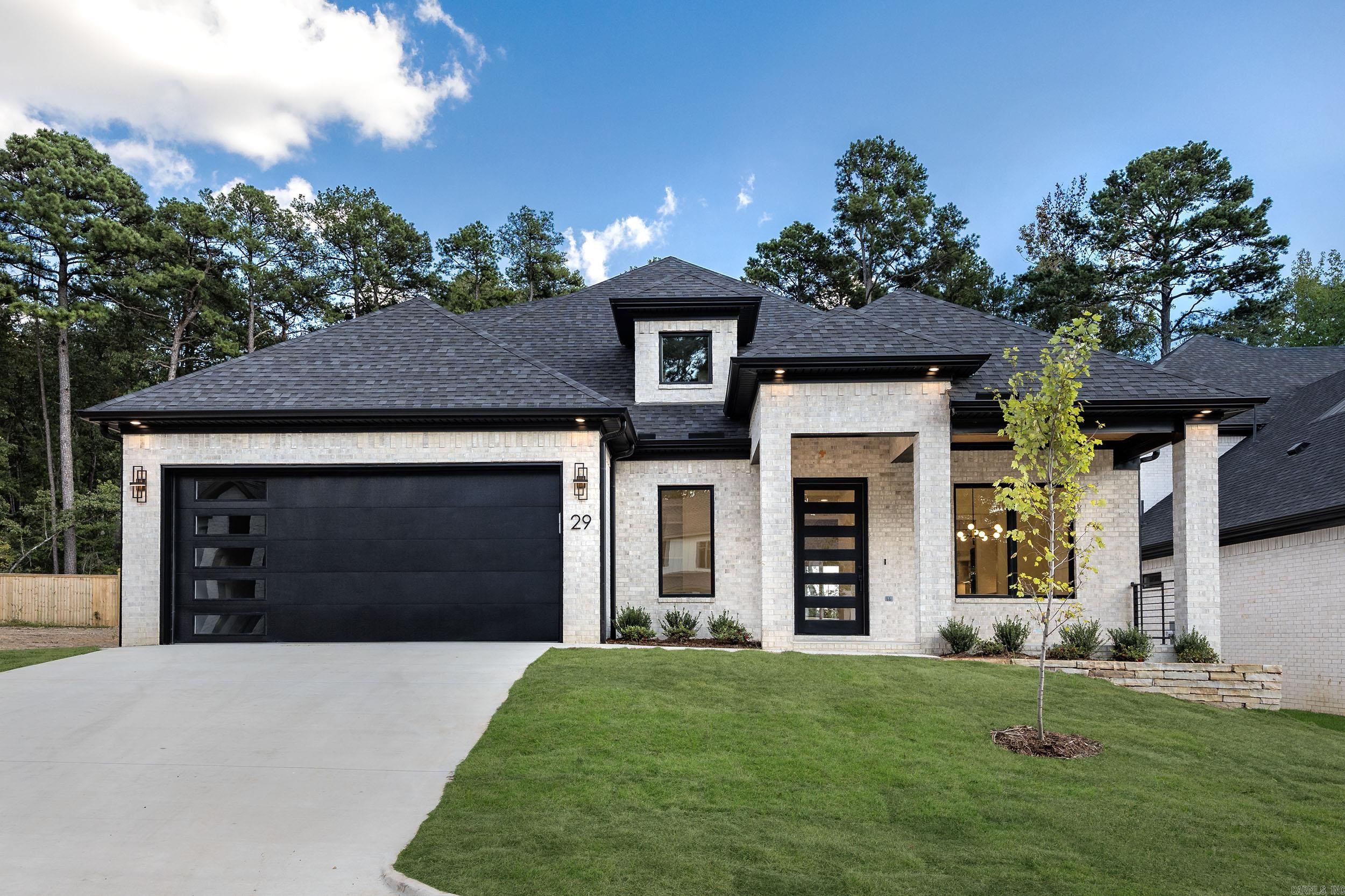 Quality construction, beautiful contemporary fixtures throughout the house. Two-level home offers 4 bedrooms and 4 bathrooms, separate office, 3 car garage, open floor plan. The main living area is the heart of the home, featuring an open kitchen with luxurious mitered waterfall island, contemporary linear fireplace with floor to ceiling tiled mantel, tray ceiling with beautiful cedar beams, and a dry bar with a beverage cooler. Covered back porch offers cozy outdoor living with a fireplace and outdoor kitchen with grill and double burner. All baths have glass shower doors. Elegant primary bath offers contemporary soaker tub, shower complete with shower head, hand spray, body sprays, and rain can shower head. All shower walls are tiled. High efficiency HVAC, energy efficient Rinnai Tank less water heater, Pella windows, smart sprinkler controller, programmable thermostats, smart switches, remote control fans, screwless switch/receptacle plates. Tons of attic storage. No carpet, all wood. Green space and fence in the back offers cozy privacy and relaxation in back porch. EV charging outlet, all good stuff. Golf-cart access to Chenal Country Club Golf course from the neighborhood.