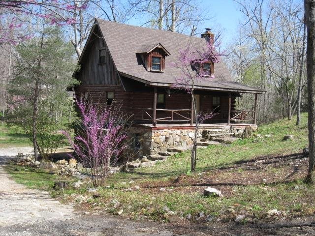 OZARK MOUNTAIN LOG CABIN with a SPRING FED CREEK BORDERING THE PROPERTY. Unique setting near a BEAUTIFUL SPRING FED LAKE! Three levels of living with 3 BRs/1-1/2 baths, native stone FP and wood stove hearth, PLUS a workshop. HANDYMAN'S SPECIAL NEEDS SOME TLC AND REPAIRS. New roof, hot water heater and plumbing repairs were made in Feb. 2014. IDEAL WEEKEND/VACATION CABIN $33,500. PRICE REDUCED TO $29,500