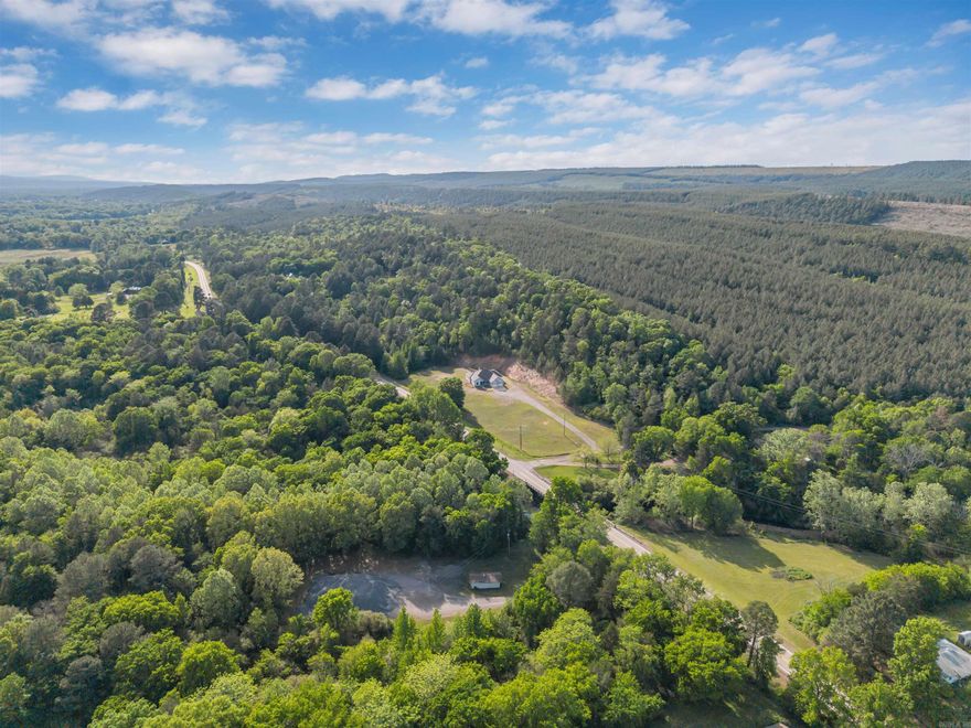 Set on 12.11 wooded acres just outside of Perryville, this updated home offers the space and privacy you’ve been looking for—with the convenience of fiber internet. Fresh interior paint, a brand-new HVAC unit, and recently resealed stained concrete floors give the home a clean, move-in ready feel. With 4 bedrooms and 3 bathrooms, the split floor plan provides both functionality and comfort. The spacious kitchen opens into a large living area centered around a cozy wood-burning fireplace, while the oversized laundry room and 3-car garage add everyday convenience. The property backs up to thousands of acres of Deltic Timber land Whether you’re looking to build a shop, enjoy the outdoors, or simply spread out and relax, this property gives you the flexibility to make it your own.