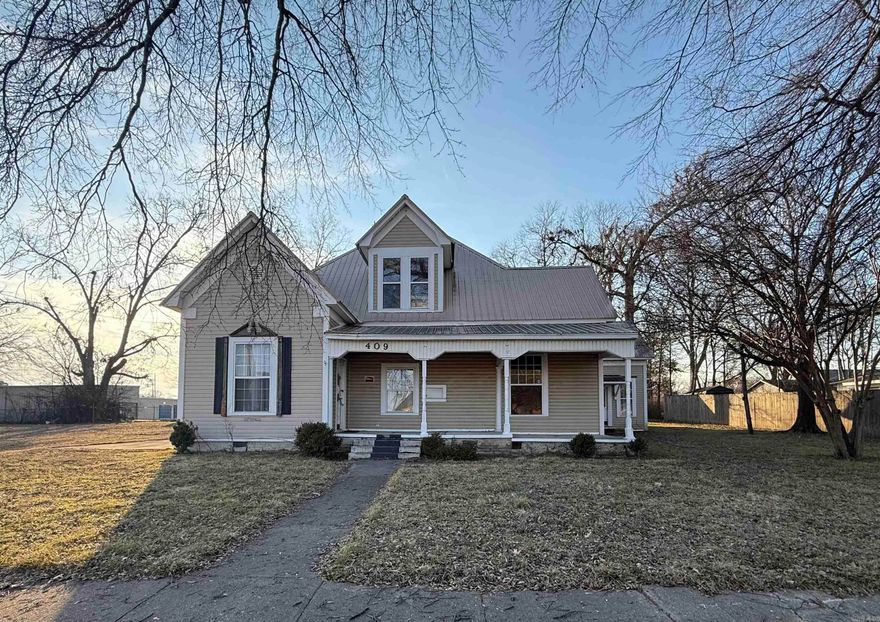 Historic property with great bones and endless potential! Situated on 3 lots and zoned residential or commercial, this property features a newer metal roof and newer windows. The main building is configured as three separate living spaces, including one larger unit with kitchen, dining area, living room, two rooms, bathroom, and a large upstairs bonus room/bedroom, plus two smaller units, each with kitchen, living area, bedroom, and bathroom. The layout allows for use as a single residence or individual units. A second building at the rear was previously used as living quarters and could be restored. The property extends through  wooded area with room to expand. Interior is in mid-renovation and ready for finish-out, making this a true blank canvas for investors, Airbnb, bed & breakfast, or redevelopment. Prime in-town location within walking distance to amenities.