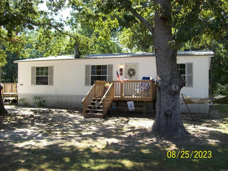 3 bedroom, 2 full bath mobile home with 2 large wooden decks.  The home features a split floor plan. The central HVAC has been repaired and working very well. The washer and dryer convey. Roof has been replaced with metal. The home only has carpet in the bedrooms, and is conveniently located on a lot that is just over 1 acres. Updated photos, fresh exterior & interior paint.   *****See Agent Remarks****