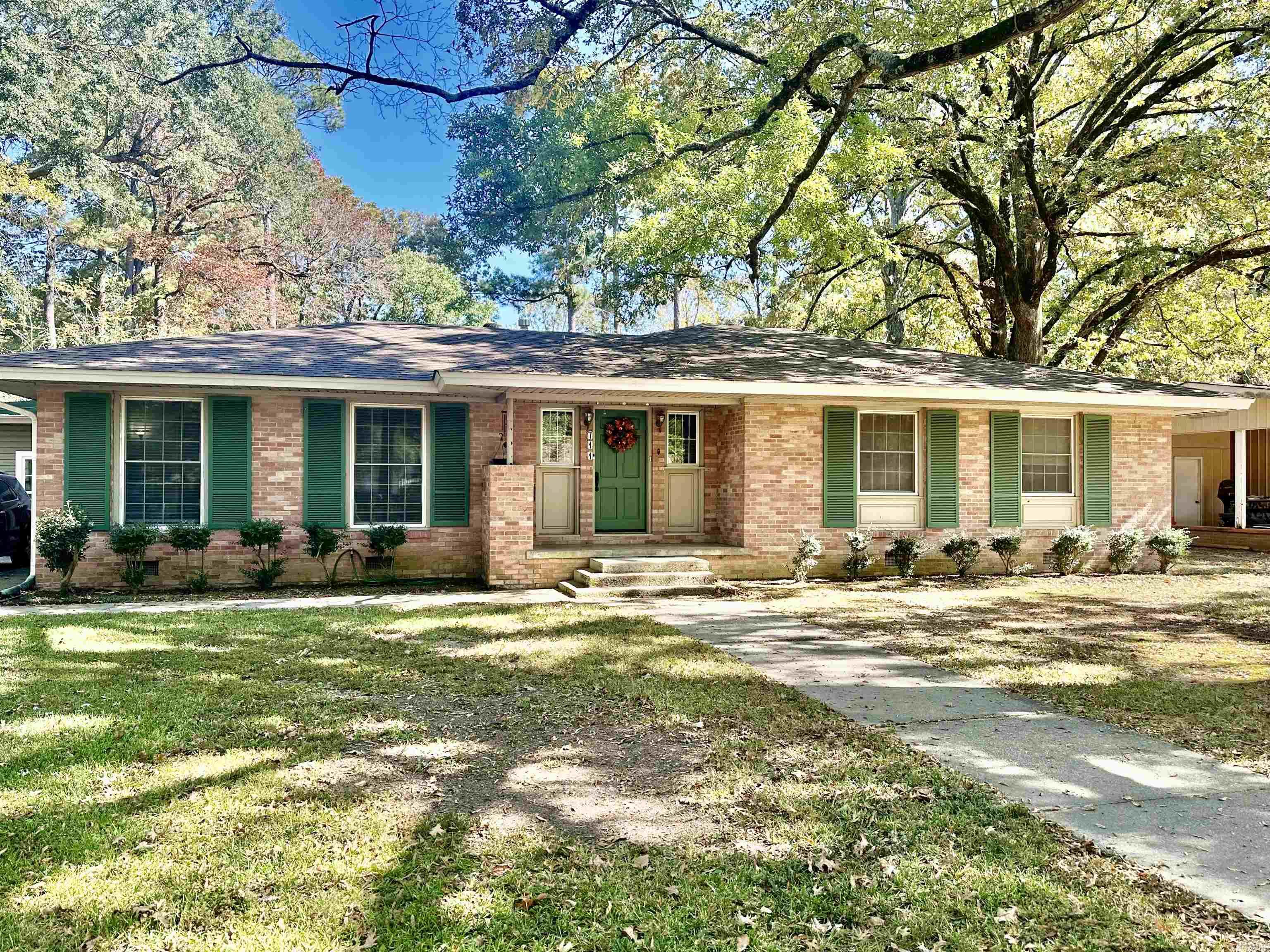 Very well-maintained older home built in 1955. Property has been mostly updated over the last 5 years. Carport was taken in as a sunroom/office with great storage. Large den with wood-burning fireplace to keep warm on those cold nights. Den has great windows to look out into the backyard. Beautiful kitchen! Updated with granite counter tops, double ovens, lots of cabinets, laundry closet with new tankless water heater. This home is plenty of entertainment space with separate dining room and formal living room. Foyer has original brick pavers. This property features 3 bedrooms and 2 updated bathrooms. New flooring in most of the home too. Roof is 3 years old, metal roof on back half of house is appx 10 years old. This is a must see to appreciate all the charm!
