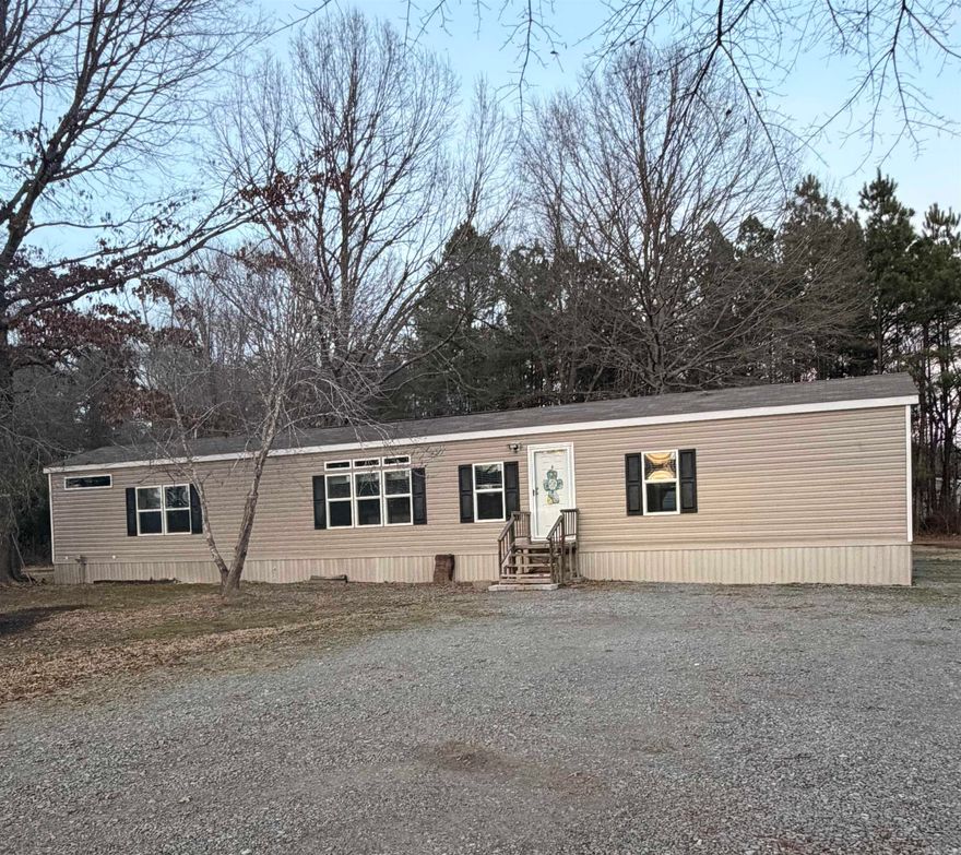 This beautifully maintained 3-bedroom, 2-bathroom mobile home, manufactured in 2021, sits on a spacious 2.48-acre rural lot offering privacy, room to roam, and endless possibilities.  The home features an open layout with really nice finishes throughout. The modern kitchen features stylish cabinetry, fixtures, and plenty of counter space, flowing seamlessly into the living and dining areas — perfect for entertaining or everyday comfort. The split-bedroom floor plan provides added privacy, with a spacious primary suite complete with a full bath.  Enjoy quiet mornings or relaxing evenings on the back porch overlooking your property. Outside, you'll also find a portable carport for convenient covered parking and a shed for extra storage or workspace.  If you're looking for newer construction, acreage, and country charm all in one package, this is the one! Schedule your showing today and experience rural living at its best!