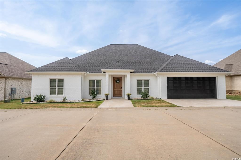 This recently built custom home on Lake Hamilton is the perfect blend of modern design and lakeside living. With 5 spacious bedrooms and 3 bathrooms, it offers ample space for family and guests. The open kitchen and living area feature a split floor plan, creating a seamless flow ideal for both entertaining and day-to-day living. The kitchen is a chef's dream, complete with a walk-in pantry, providing plenty of storage space and functionality. The large primary ensuite is a true retreat, offering privacy and luxury with beautifully appointed finishes. Outdoor living is equally impressive, with a fully fenced backyard, perfect for pets or play, and a single-stall boat dock that provides year-round water access for all your boating adventures. This all-brick home is located in a gated neighborhood, adding a layer of security and community amenities such as a pool, perfect for relaxing on warm days. Whether enjoying the stunning views of Lake Hamilton or the convenience of this thoughtfully designed home, this property has everything you need for lakeside living at its finest.