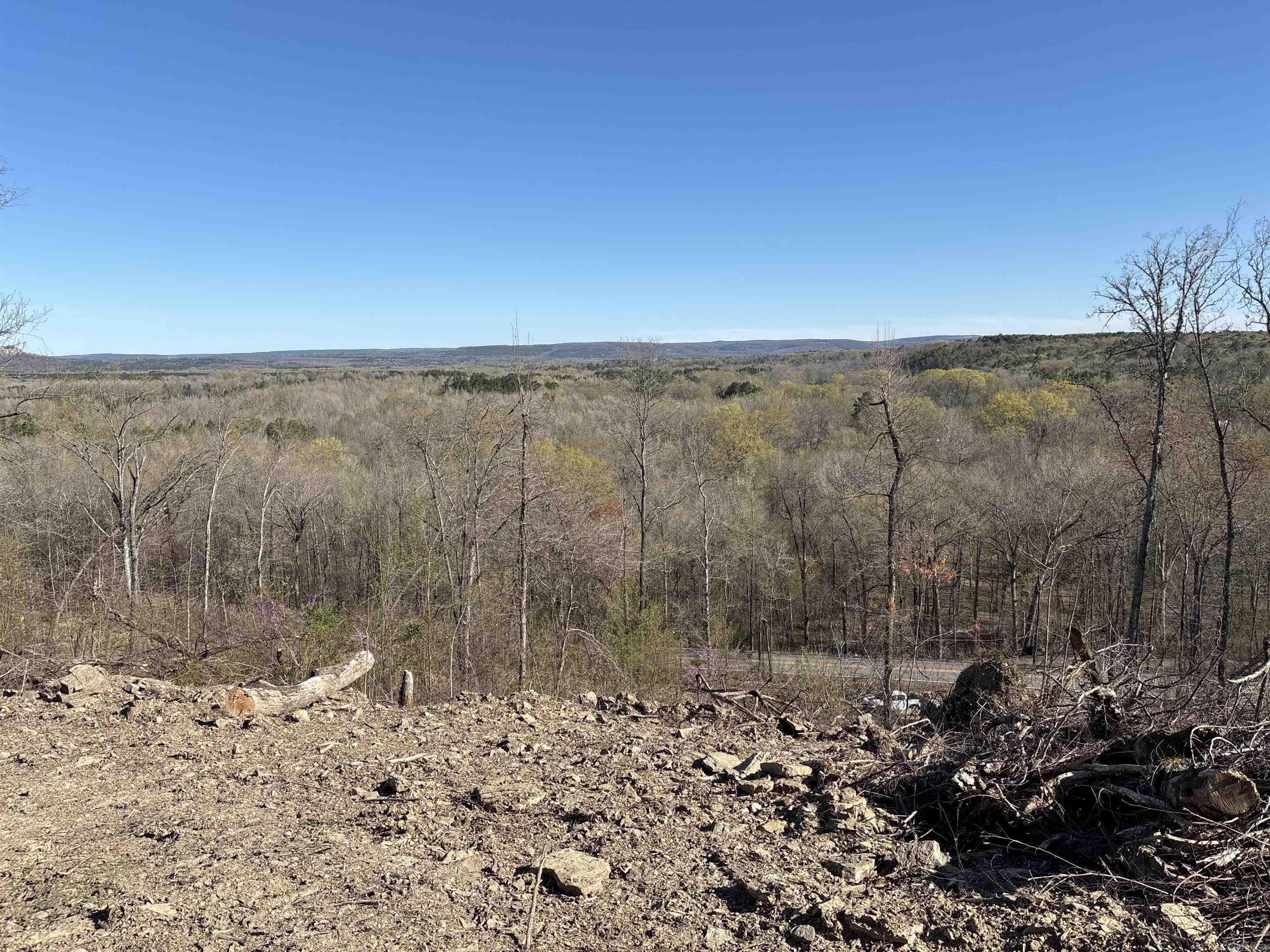Hilltop Retreat off the Little Red river located just east of Heber Springs on Libby Road. This property has been cleared and roads built for easy access to most of the property. The land is on a HILLSIDE with several flat areas or ledges that can be developed into several homes or just one estate house. The land has River view from the top to bottom of property. Equipment to continue development can be purchased separately from the land purchase. The ground has been cleared and improved since a tornado devastated the area several years ago. This parcel has potential for several uses lets go look and see.