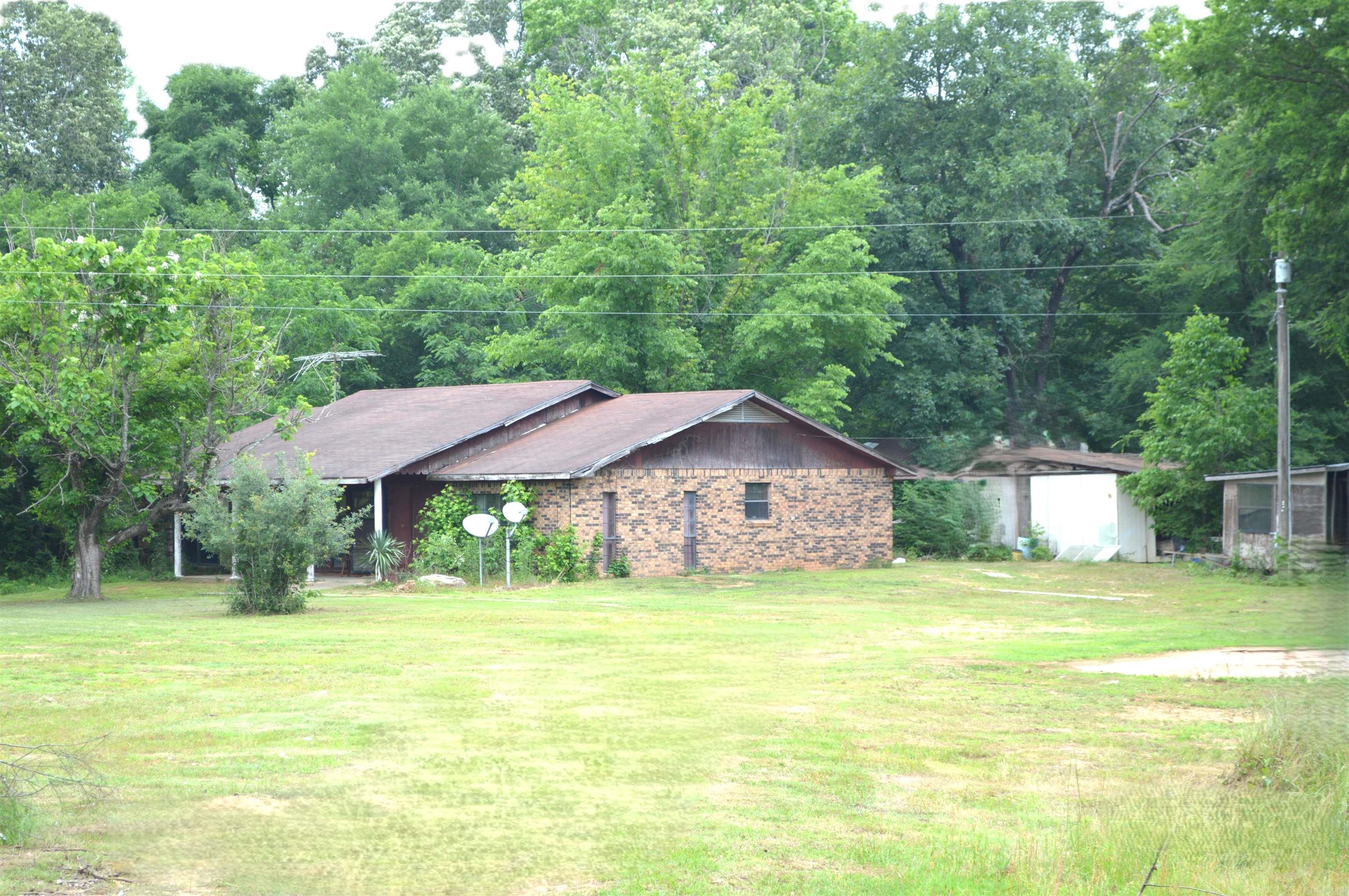 Family home place being sold in as is condition land is mostly wooded has 2 old poultry houses used for storage. There is a fishing pond, a couple of mobile home set ups on the property. Has rural water plus 2 private wells and a septic system.