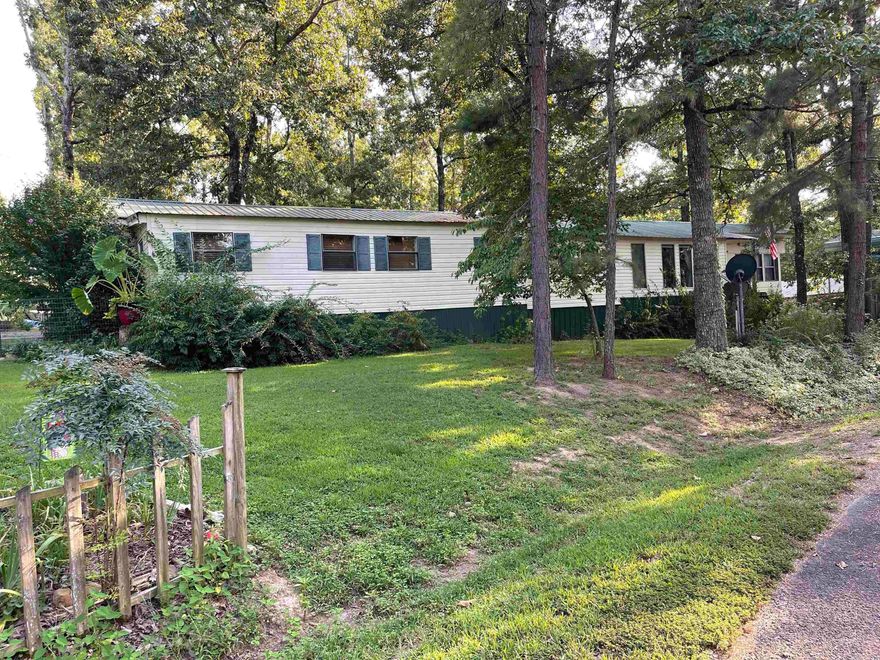 Look at this cute home in Frontier Canyon! This home has room for all your family and friends plus it is just a half mile to the boat launch. Plenty of parking for lake toys and guests and lots of room outside to enjoy nature. The inside has 3 beds/3 full baths with options to have more rooms. The master bedroom has vaulted wood ceiling with hard wood floors and a separate outdoor entrance.  All the appliances were new in 2022 including the 2 mini splits. Large living room with a gas fireplace, tons of storage throughout the home. Some more awesome features about this house are 3 driveway entrances, BBQ patio area, Koi Pond, Fenced dog area, 2 water heaters, city water and well, storage sheds, garage and so much more.  Give me a call today!  Agents please check agent remarks!