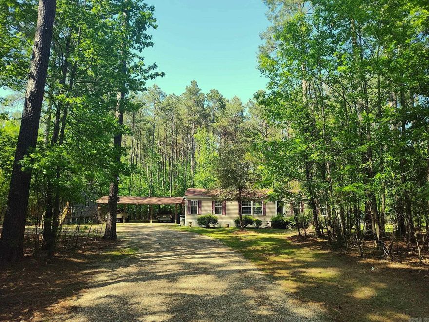 Imagine yourself with your own private park in your backyard. Owner has meticulously put in beautiful winding pathways in the back acreage.   This 3 bedroom 2 bathroom house sits on 3.01 acres. This spacious and well maintained double wide mobile home has an open floor plan and updated flooring. The large bedrooms all have walk-in closets.   Home was temporarily removed from the market so that seller could add improvements to the home, such as a new 8 foot wooden privacy fence adding to the feeling of total serenity. Gray 32x12 shop just put in in 2022 stays with the home along with a 10 x16 tool shed for plenty of storage. 3 car carport to provide covered parking as well. All new major appliances. ‘Seller to include professional cleaning after closing’