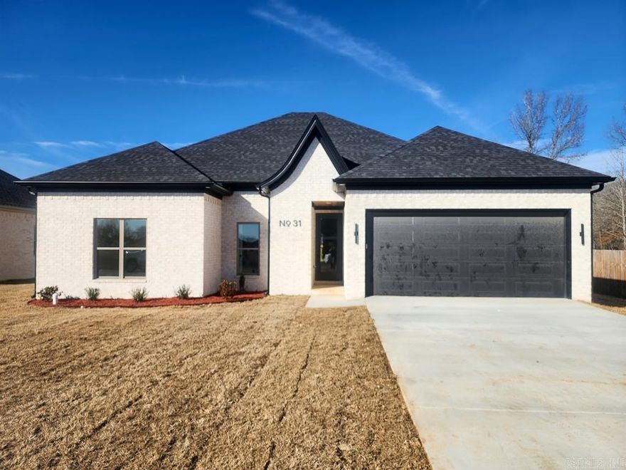 New construction in the East Meadows subdivision within the Greenbrier city limits, built by TET Homes & Construction LLC. This 1,858 square foot, 4-bedroom, 2-bath home offers a well-designed split floor plan with modern finishes throughout. LVP flooring runs through the entire home, complemented by quartz countertops in both the kitchen and bathrooms.  The open living area features an electric fireplace and flows seamlessly into the kitchen, where a large island with breakfast bar seating anchors the space and leaves ample room for a dedicated dining area. The primary suite is thoughtfully appointed with double vanities, a soaking tub, a custom tile walk-in shower, and separate his-and-hers walk-in closets.  Enjoy the oversized covered back porch, positioned to face north for a shaded and comfortable outdoor living space. Additional features include an attached two-car garage, all-electric construction, and public water and sewer through the Greenbrier Water Department. A one-year builder warranty is included for added peace of mind.  A quality-built home offering space, function, and contemporary style in a growing Greenbrier neighborhood.