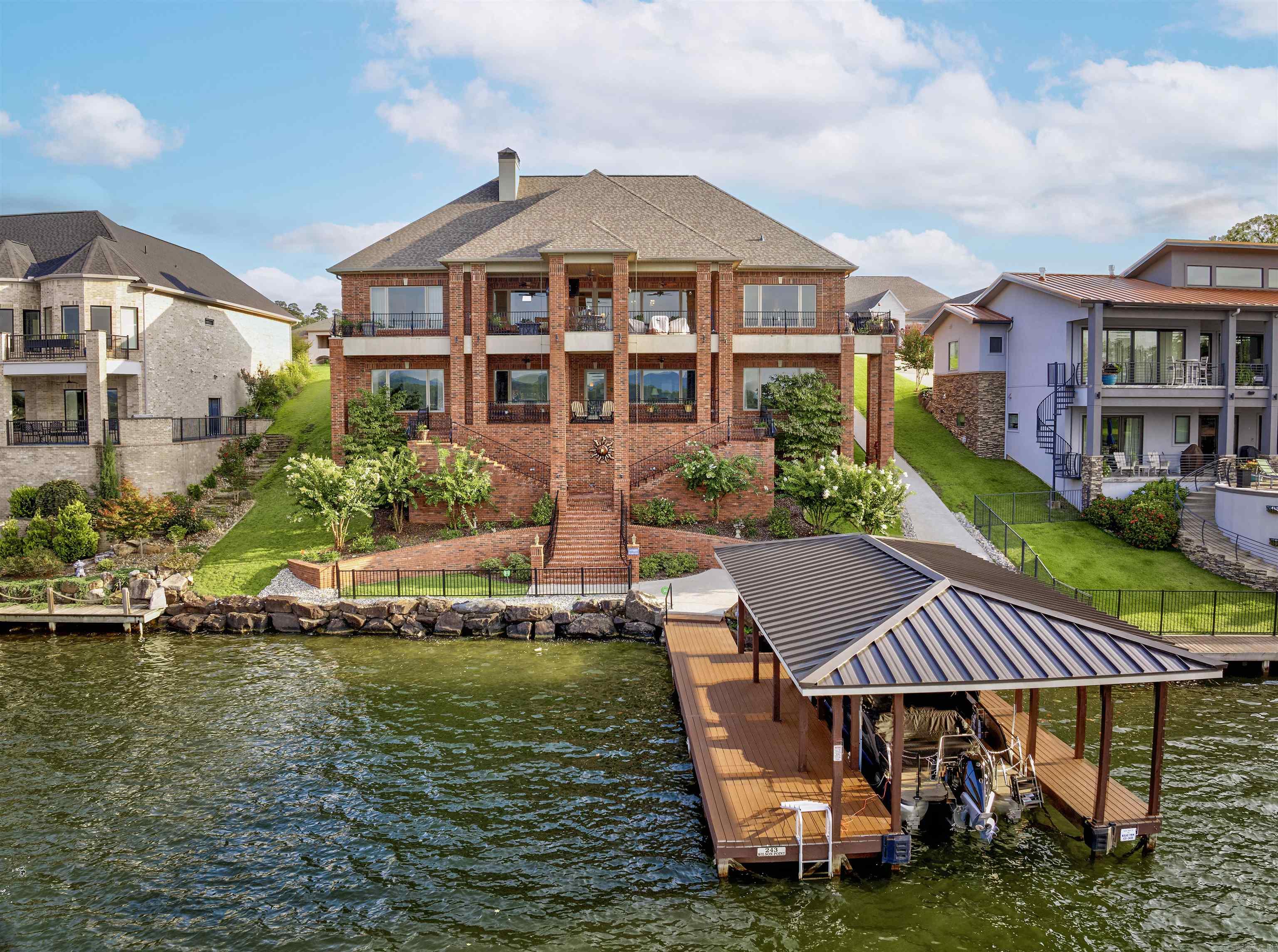 A rare offering on Lake Hamilton, this exceptional custom-built waterfront estate blends architectural refinement with understated luxury. Designed for elegant living and effortless entertaining, the home features 5 bedrooms, 5.5 baths, a gourmet kitchen with granite countertops professional grade appliances, and a separate lower-level suite with full kitchen ā ideal for guests or multi-generational living. The gracious primary suite offers a spa-like retreat with an expansive walk-in closet, while a dedicated office adds practicality to the timeless design. Outdoors, enjoy a thoughtfully created cart path to the water, refinished dock and boat lift, and inviting entertaining spaces overlooking the water. A true expression of Southern elegance, every detail adds a touch of Lagniappe on the lakeā that ālittle bit extraā that sets this property apart. (Full house generator is present and a full list of updates and improvements available upon request.)
