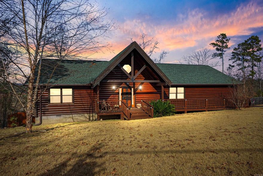 Welcome to an unforgettable log home retreat in the Lakeside School District! A rare gem offering true rustic cabin living with seasonal lake views WITH neighborhood lake access! This three bedroom two bath beauty radiates warmth, character, and rustic lake life energy. Inside, rich wood tones create a cozy yet impressive atmosphere. Spacious bedrooms feel like private retreats, cedar lined closets add classic cabin charm, and the ADA compliant primary bath with roll in shower offers comfort and accessibility. A heated and cooled basement room provides flexible bonus space for a gym, office, studio, or storage. Outdoor living shines with a screened back porch with lake views, a fully fenced yard enclosed by a five foot black vinyl coated chain link fence, and a separate shop ideal for hobbies or lake gear. An in ground Rain Bird sprinkler system keeps both front and back yards lush and inviting. Major updates add confidence and value, including a new roof on the house, shed, and carport, a new WiFi AC and heat pump, and a new heat pump water heater. Security doors on all entrances offer peace of mind. This is a truly one of a kind find!  Schedule your showing today!