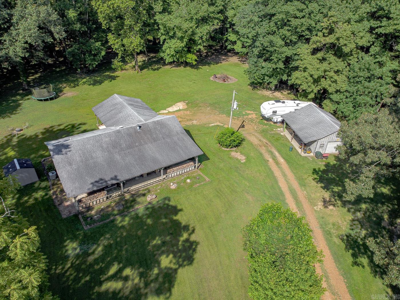 Welcome to market a 3 bd 2 bath home tucked away on 9.19 secluded acres across 5 parcels near Lake St. Francis. This hidden gem offers privacy, nature, and space to roam. A mix of wooded land & open space makes it ideal for outdoor enthusiasts or those seeking peace & quiet on the outskirts of town. Offers 1,412 SF w/ a cozy LR/DR combo showcasing vaulted ceilings & a wood-burning fireplace. The eat-in kitchen offers a breakfast bar, pantry, dishwasher, disposal, built-in oven, and electric cooktop. The split floor plan includes a spacious ownerās suite, 2 guest bdrms, & guest bath. A mudroom/laundry combo adds convenience, and all major systems are electric and in great condition. Attached carport sits on a concrete slab with LED lighting & Bluetooth capability. Additional features: 20x26 wired shop w/ manual lift, LED lights, Bluetooth, plumbed for compressed air, hose reel, 30-amp RV hookup, and 240-volt 50-amp connection. An 8x10 storage shed. Sellers will include all yard equipment w/ a reasonable offer. Ask for the full item list! Priced w/ cosmetic updates in mind. 2 yr supply of firewood ready. Septic inspected 2023, survey available, termite contract. Call today to tour