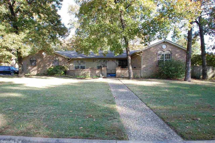 Convenient Location! Traditional Pleasant Valley 1 level home. Corner large level lot.  Across from green space.  Approx. 2519 SF with 2 living areas, 4 bedrooms and 2 1/2 baths. Hardwood floors in living/dining, hall and all bedrooms.  Tiled bathrooms (one is a jack n jill).  Den with FP.  Kitchen with eat-in area.  Roomy utility room w/ 1/2 bath. L shaped fenced backyd. Roof, heat and air, 2 HWHs-- 10 yrs or less.  More info on file. With a little updating, what a spectacular home this will be!!