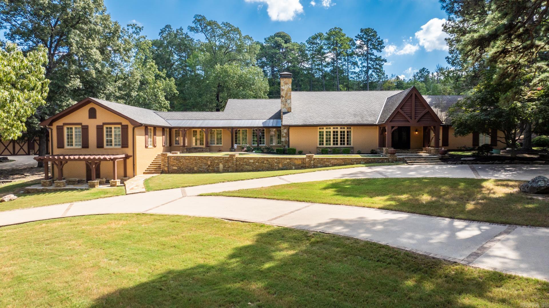 Experience convenient country living with 6+ Beds, 5 Full Baths, 4 Half Baths, and a pool, just off Toad Suck Ferry Rd in Conway! Enter through the gated driveway to a private estate featuring copper gutters and updated Pella doors/windows. Inside, a vaulted living area with a gas fireplace, open kitchen with two breakfast bars, sub-zero freezer drawers, and double dishwashers. Nearby, find a private half bath, office, and locker room with Elfa shelving. The second living area includes a wet bar, ice maker, and built-in library. Formal dining opens to a covered patio with iron gates, leading to a 9ft heated saltwater pool, basketball court, and playground. The primary suite features a beamed ceiling, air tub, walk-in shower, and double closets. Two guest beds, a laundry room, and a sunroom connect to additional guest suites. The lower level boasts a game room, kitchenette, office, and concrete safe room. A detached cedar garage includes a workshop, washer/dryer, and an in-law suite. Security system, propane tank, and backup generator included.