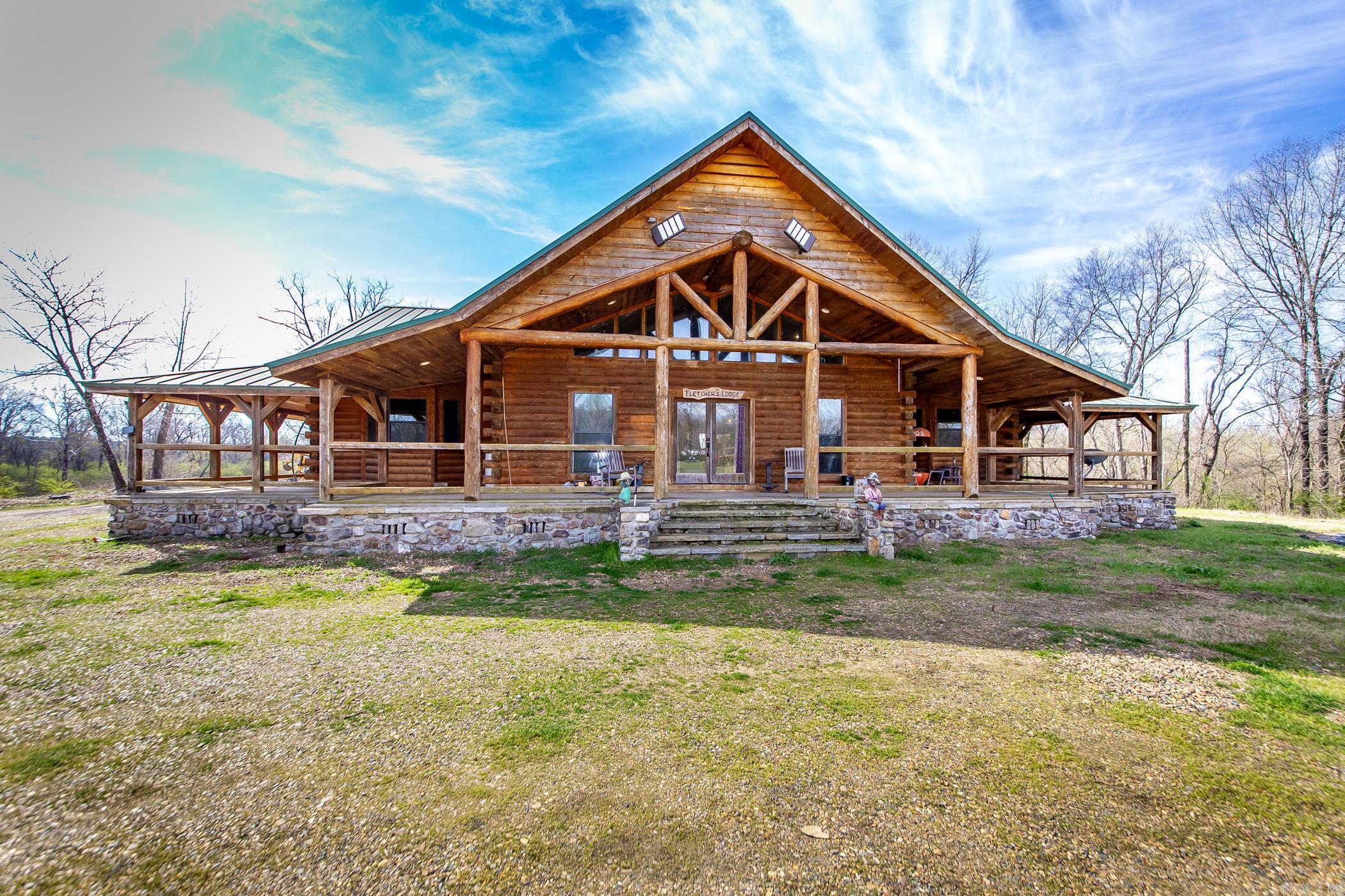 Exclusive Riverfront Retreat with Acreage, Investment Potential, and Endless Possibilities. Discover the perfect blend of luxury, privacy, & investment potential in this stunning 2,864 square-foot home, nestled on 75 acres with over 3,500 feet of Ouachita River frontage. With 3 spacious bedrooms & 2 bathrooms, this home features a massive walk-in shower, commercial-grade appliances, and a large wood-burning fireplace. The open-concept living area boasts tall vaulted ceilings that create an inviting atmosphere, while the wrap-around porch offers stunning views of the river and surrounding landscape. Whether youāre sipping coffee or watching the sunset, this space offers the perfect backdrop for any occasion. The expansive 4-car carport/patio provides plenty of room for vehicles, storage, or entertaining guests. This property is a nature loverās dream, offering a pond, pasture land, and wooded areas, ideal for hunting, fishing, and outdoor activities. Enjoy unmatched privacy, all with easy access to I-30 for convenience. In addition to the tranquil living experience, this property presents exceptional investment opportunities.