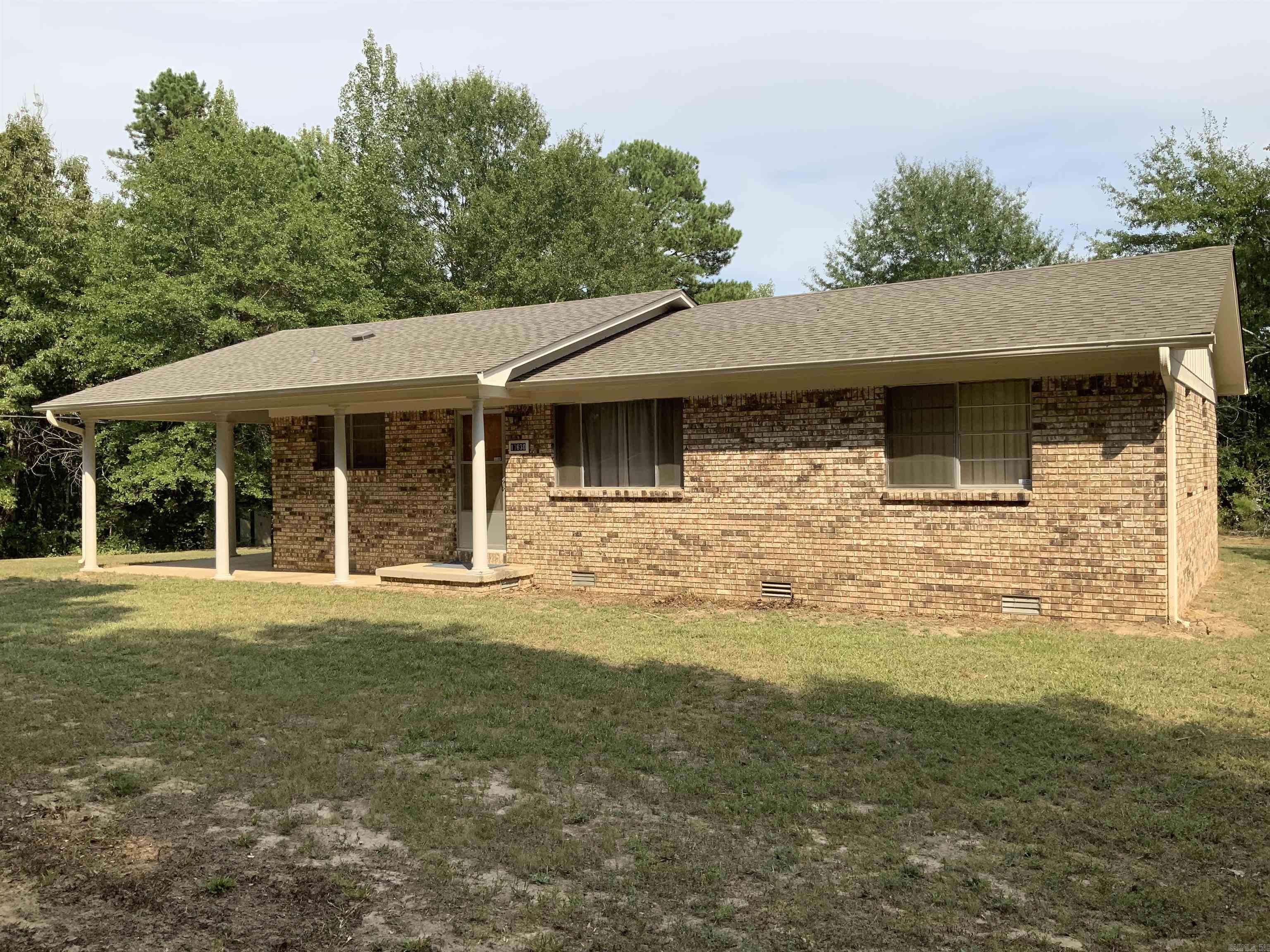 This charming 3 bedroom, 1.5 bath home, located on a generous 5 acres in the Sheridan School District, offers a unique private setting. Key features include a new roof, updated exterior paint, and recent renovations with new LVP flooring in the kitchen and hallway, as well as new ceramic tile in the bathrooms. Original hardwood floors add character to the living areas and bedrooms. The spacious eat-in kitchen comes equipped with a wall oven and a built-in electric stove, perfect for family gatherings. The property is beautifully landscaped with mature trees, and additional amenities include two storage sheds with electricity, a pole barn, and a storm shelter. FirstConnect Fiber internet is available through First Electric.
