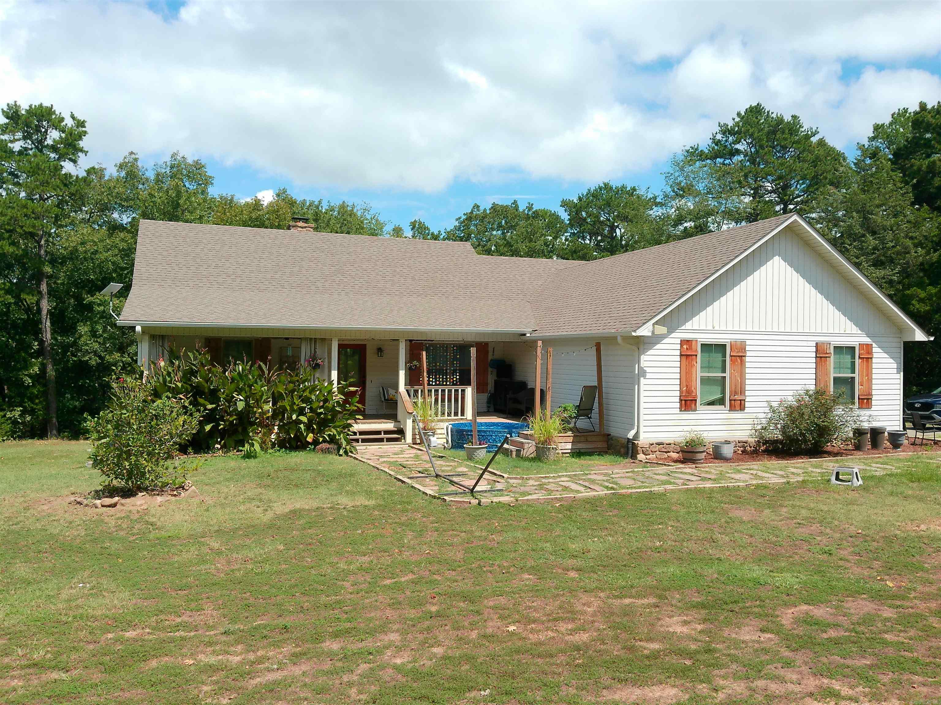 Here it is - Beautifully designed custom built home sitting on 20 rural acres, yet easy access to Dover & Russellville. Large open living area featuring a fireplace with an insert and connecting with a gourmet kitchen, custom tongue & groove ceilings in some rooms and two large, covered porches overlooking the woods that will be perfect for cooking out and relaxing at the beginning or ending of each day. Fenced in garden spot for spring planting. This is a must see. Refrigerator, washer & dryer are negotiable. Unbelievably, the sellers say that the MINERAL RIGHTS CONVEY!