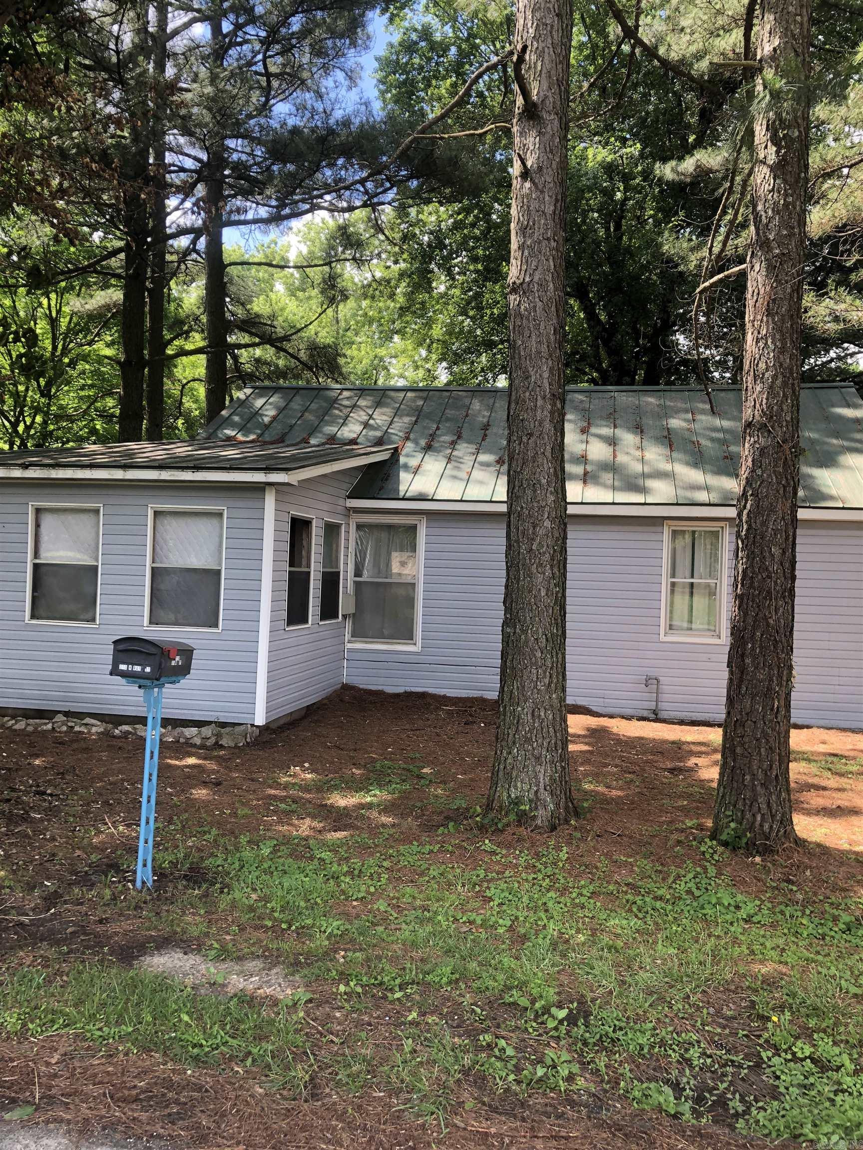 Investors if you are looking for a home with potential and a garage located on the same lot with the home then check this out. With this "fixer-upper" home there are numerous possibilities. The home is located on a corner lot and has space if you wanted to build in the future two small homes for rental purposes. The garage has units for heating and cooling , storage & office space. Pass by this house and see if this looks like a potential investment for you. Owner is motivated and selling home AS-IS.