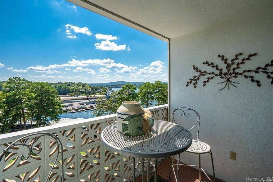 Updated and charming Lake Hamilton condo with a private balcony overlooking the water. This condo has everything you want:  Good views, nice appliances, cheerful kitchen, updated bathroom with lots of storage and a walk in shower, remote controlled window coverings, large walk in closet, and attractive furnishings in an interior designed by a decorator.  All this is located in a prime lake location with spacious and beautiful gated grounds.  There is a large pool adjacent to a covered patio, tennis and pickleball courts, BBQ grills, a family / party room, an exercise room, elevators, and so much more!  Nightly rentals are allowed for potential extra income.