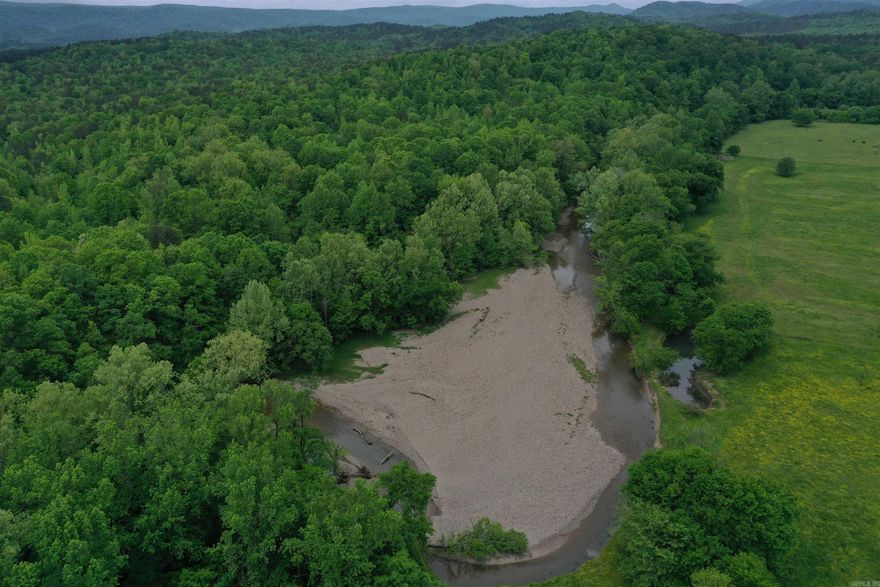 Located just outside of Norman in the community of Black Springs, this Montgomery County 174+/- acres is loaded with hard to find features and has something for everyone! The crystal-clear waters of the Caddo River are some of the most sought after in the region, and after taking a look at the beautiful river frontage on this property it will be easy to see why. As you pull through the steel gate and entry way, you’ll wind down the gravel drive up to a park like hilltop overlooking the river. Relaxing by the fire and listening to the babbling of the shoal directly below the hill is the definition of relaxation for many. From the cleared build site, it is an easy walk or side by side ride down the hill right to the edge of the water. Whether you enjoy fishing, floating, or just spending some time with your toes in the water, this is the perfect place for you. Along with the half mile of frontage along the Caddo River, the property boasts 1.2 miles of boundary with the Ouachita National Forest, giving access to hundreds of thousands of acres for hunting, fishing, hiking, and enjoying The Natural State.