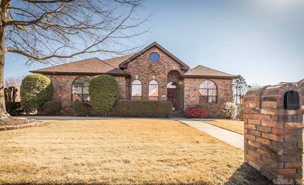 Updated, versatile and serene setting. Located on neighborhood pond with waterfall, screen porch, dual decks for peaceful outdoor living. 4 Bedrooms- main level with 3 living areas. Updated master bath- soaker tub, tile, vanity and shower. Chef's kitchen- granite, Advantium, Jenn-air 4 burner gas, stainless appl. Large in-law or teenage quarters w/mini kitchen. 4 Car garage (2 are climate controlled), roof 2010, 2 tankless HWHs. Walking trails, short golf cart ride to Country Club.