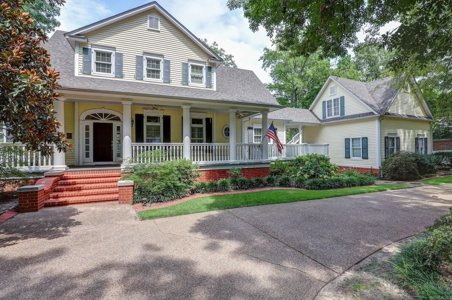 This beautiful, gracious Southern-style home is situated on a private lake in a highly desirable neighborhood, offering over 3,600 square feet of elegant living space, plus an additional efficiency GUEST APARTMENT complete with a kitchenette and full bath. The main house features 3 bedrooms and 3.5 baths, including a luxurious master suite on the first floor with a spacious en-suite bathroom and a huge walk-in closet. The oversized family room boasts two-story coffered ceilings and magnificent lake views, complemented by a cozy fireplace. A charming den off the kitchen, also with a fireplace, and an additional upstairs game room both offer stunning vistas of the lake. The property includes a two-car attached garage and a DETACHED GARAGE/WORKSHOP with a screened room overlooking the serene water. The upstairs hosts two oversized bedrooms, each with its own en-suite bathroom. Spectacular landscaping enhances the beauty of this home, with springtime bringing a riot of azaleas. Outdoor living is made easy with a large covered front porch and expansive back decks, perfect for enjoying the tranquil lake views.