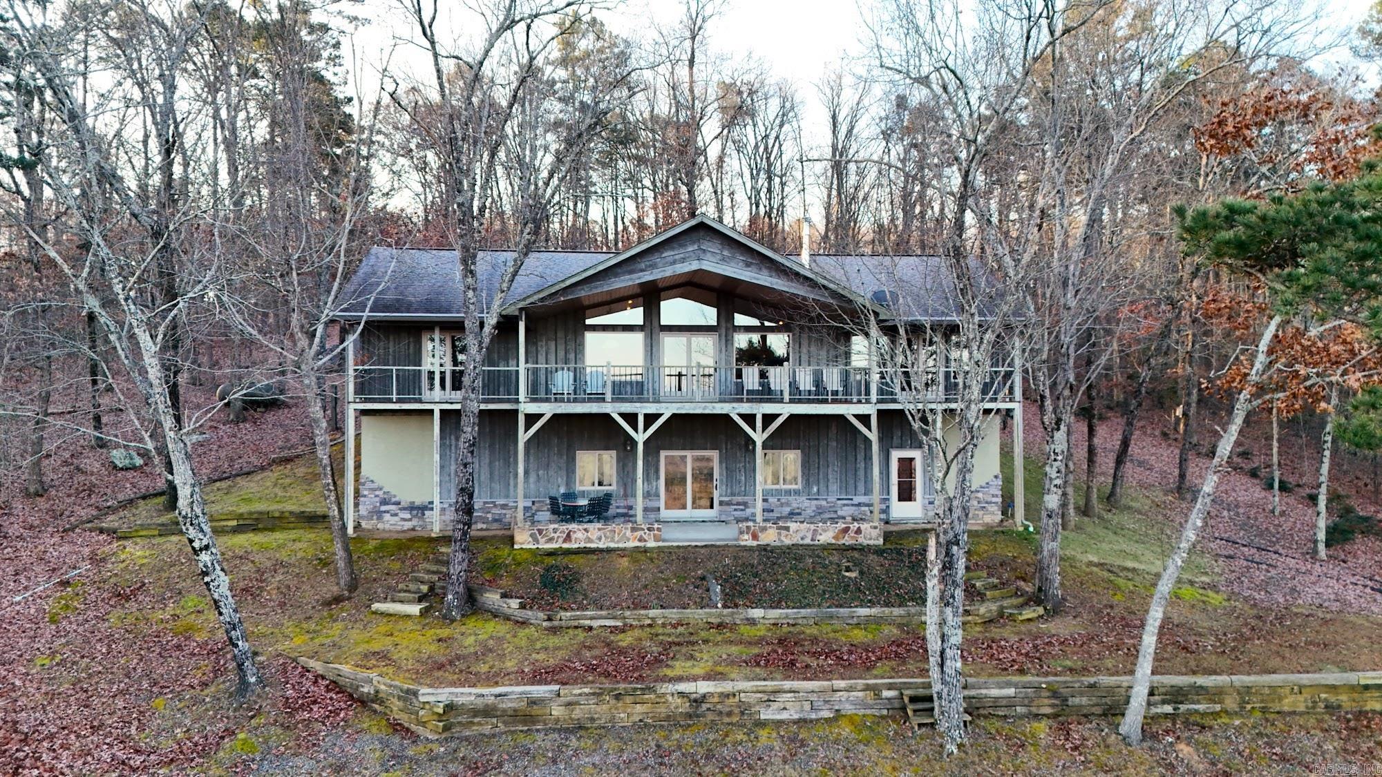 What a view!! Panoramic overlooking Sugarloaf Mountain, Little Red River and the valley. Pictures don't do it justice, must see. Whether just entertaining guest on the weekends or full time living this is comfortable home. Two bedrooms and two baths on main level, with kitchen/dining and a spacious sun room. Two bedrooms, a bath, partial kitchen/entertaining and a safe room downstairs. Both levels offer walk outs with porches to take in the view, did I mention the VIEW? Schedule a showing and don't miss this one. Measurements are encouraged. Agents see agent remarks.