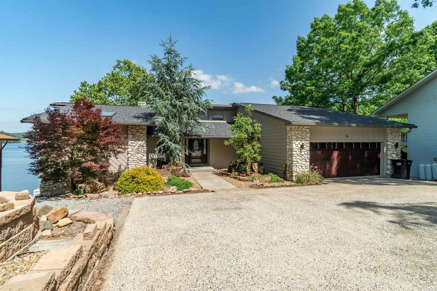 Summer time Price Improvement!  Start Living your best life NOW!  Lakeside Living at its Finest! Welcome to 54 Rubi Circle—where lakeside luxury meets modern comfort in the heart of Hot Springs Village. This beautifully remodeled water front offers sweeping views of the serene, 245-acre Lake Cortez, creating an ideal retreat for lake enthusiasts. Spend your days kayaking, fishing, boating, swimming, or simply relaxing by the shore. Inside, enjoy recent upgrades including two Lennox HVAC systems with Wi-Fi thermostats, energy-efficient windows and doors, instant hot water systems in the kitchen and bathrooms, and heated flooring in the primary bath. A whole-house generator powered by a buried 500-gallon propane tank provides year-round peace of mind. The lower level features a spacious family room and a versatile flex-room with a closet (no window)—ideal for guests, an office, or hobbies. Garland County tax records list the home as three bedrooms. 54 Rubi Circle offers more than a home; it offers a lifestyle.  Living at 54 Rubi Circle means more than just a beautiful home; it's about embracing a vibrant community.  Don't miss this opportunity to own a slice of paradise.