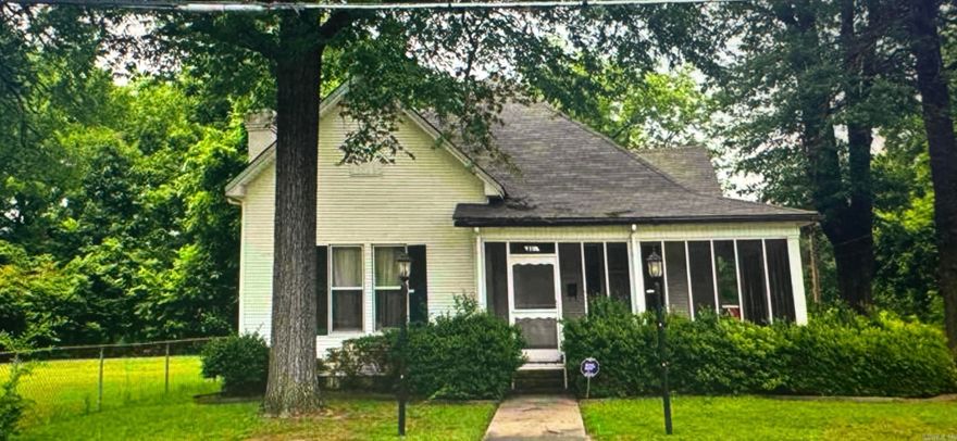 Welcome to this charming 2-story home nestled on a corner lot in Pine Bluff. Offering 3 bedrooms and 1 bath, this home blends classic character with functional space. The primary bedroom is conveniently located on the main level, with two additional bedrooms upstairs.  Inside, you’ll find a formal living room, den, and dining room—perfect for both everyday living and entertaining. Cozy up by the wood-burning fireplace or relax on the screened-in front porch and enjoy the peaceful surroundings.  The property also includes a garage, central heat and air, and an additional lot—providing endless possibilities for expansion, investment, or outdoor enjoyment. With just a little vision and care, this home could truly shine. Call today to book your tour!!!