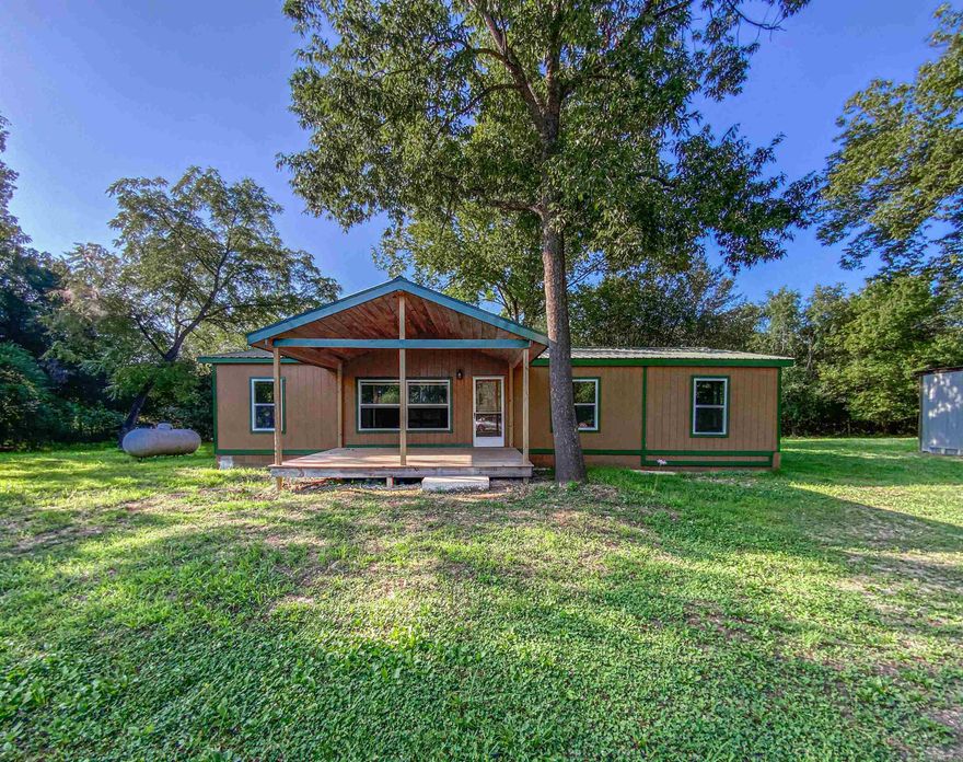 Looking for country living, close to lake, move in ready?  This is your place. Sitting on 1.39 m/l level acres is the 1996 Doublewide home that has been completely remodeled.  New vinyl plank floors, all new windows, light fixtures, ceiling fans, brand-new stainless-steel appliances, 2 covered decks.  There are 3 bedrooms and 2 full baths.  Both bathrooms have been updated with step in showers and new toilets.  A bonus room and mud room have also been added to allow lots of storage and space to use as you see fit.  Home is on block foundation and boarders corp property that connects to West Sugarloaf Creek.