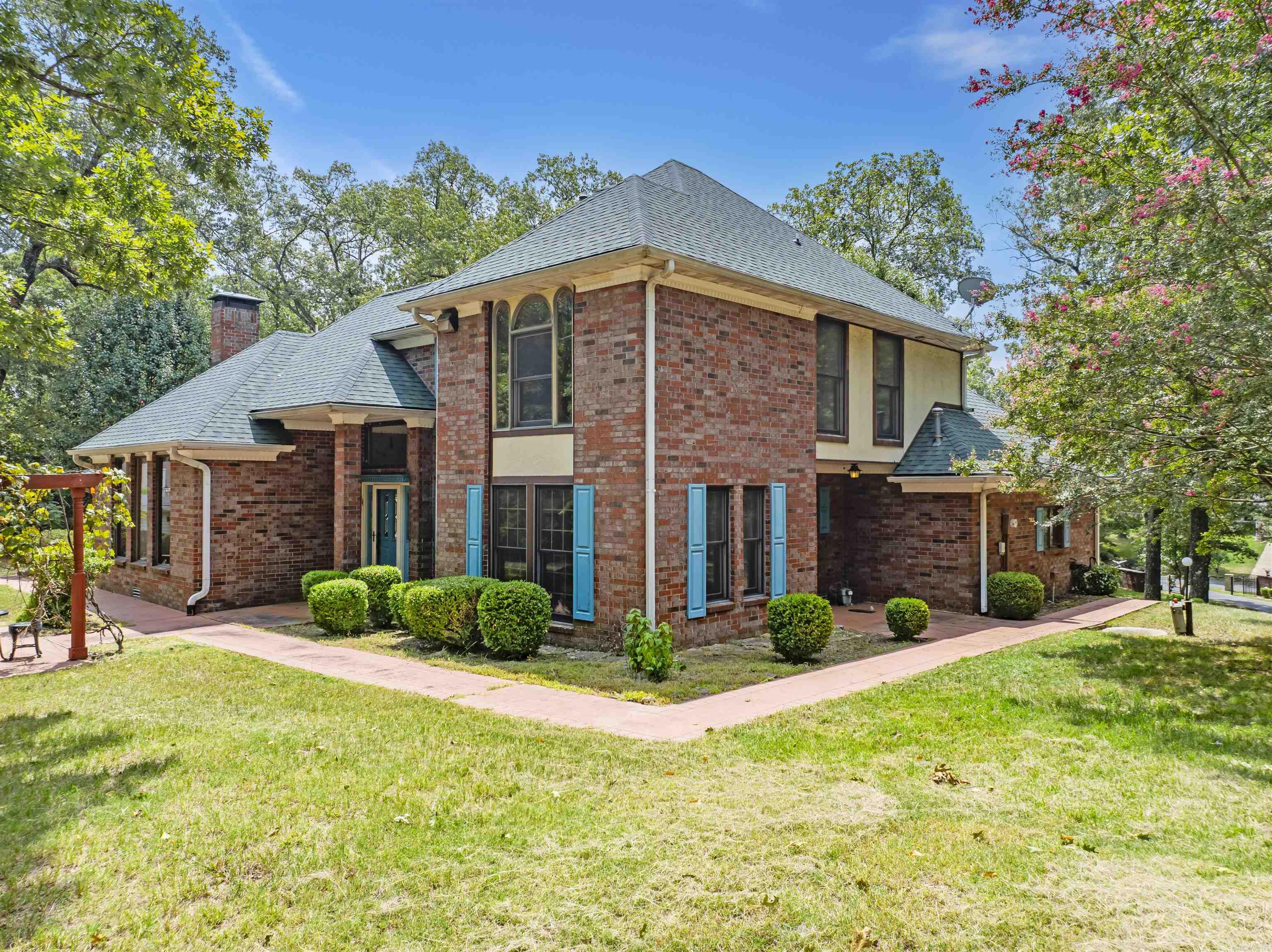 The Opportunity of a Lifetime on Lake Hamilton! Situated on a sprawling 3.83-acre lot in Hot Springs National Park, this rare and historic lakefront estate offers over 500 feet of shoreline along the main channel with unobstructed views of the lake and surrounding mountains. The 2,672 sq ft single-level home features 4 bedrooms, 2.5 bathrooms, and a cozy fireplace, making it the perfect blend of comfort and elegance. A paved driveway leads you through a wrought iron gated entry to a true lake oasis, complete with extensive landscaping, a beautiful waterfall, and a stone and brick patio at the water’s edge. Boating enthusiasts will love the private boathouse with lift, while the lake pump sprinkler system keeps the grounds vibrant year-round. For added convenience, there’s a 2-car attached garage plus a 3-car detached garage for extra storage. Whether you're relaxing on the spacious porch, enjoying lake activities, or taking in the natural beauty, this property offers an unmatched opportunity to own a private retreat in one of Arkansas’s most desirable lakefront locations.