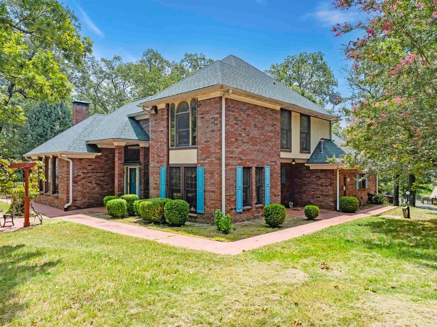 The Opportunity of a Lifetime on Lake Hamilton!  Situated on a sprawling 3.83-acre lot in Hot Springs National Park, this rare and historic lakefront estate offers over 500 feet of shoreline along the main channel with unobstructed views of the lake and surrounding mountains. The 2,672 sq ft single-level home features 4 bedrooms, 2.5 bathrooms, and a cozy fireplace, making it the perfect blend of comfort and elegance.  A paved driveway leads you through a wrought iron gated entry to a true lake oasis, complete with extensive landscaping, a beautiful waterfall, and a stone and brick patio at the water’s edge. Boating enthusiasts will love the private boathouse with lift, while the lake pump sprinkler system keeps the grounds vibrant year-round. For added convenience, there’s a 2-car attached garage plus a 3-car detached garage for extra storage.  Whether you're relaxing on the spacious porch, enjoying lake activities, or taking in the natural beauty, this property offers an unmatched opportunity to own a private retreat in one of Arkansas’s most desirable lakefront locations.