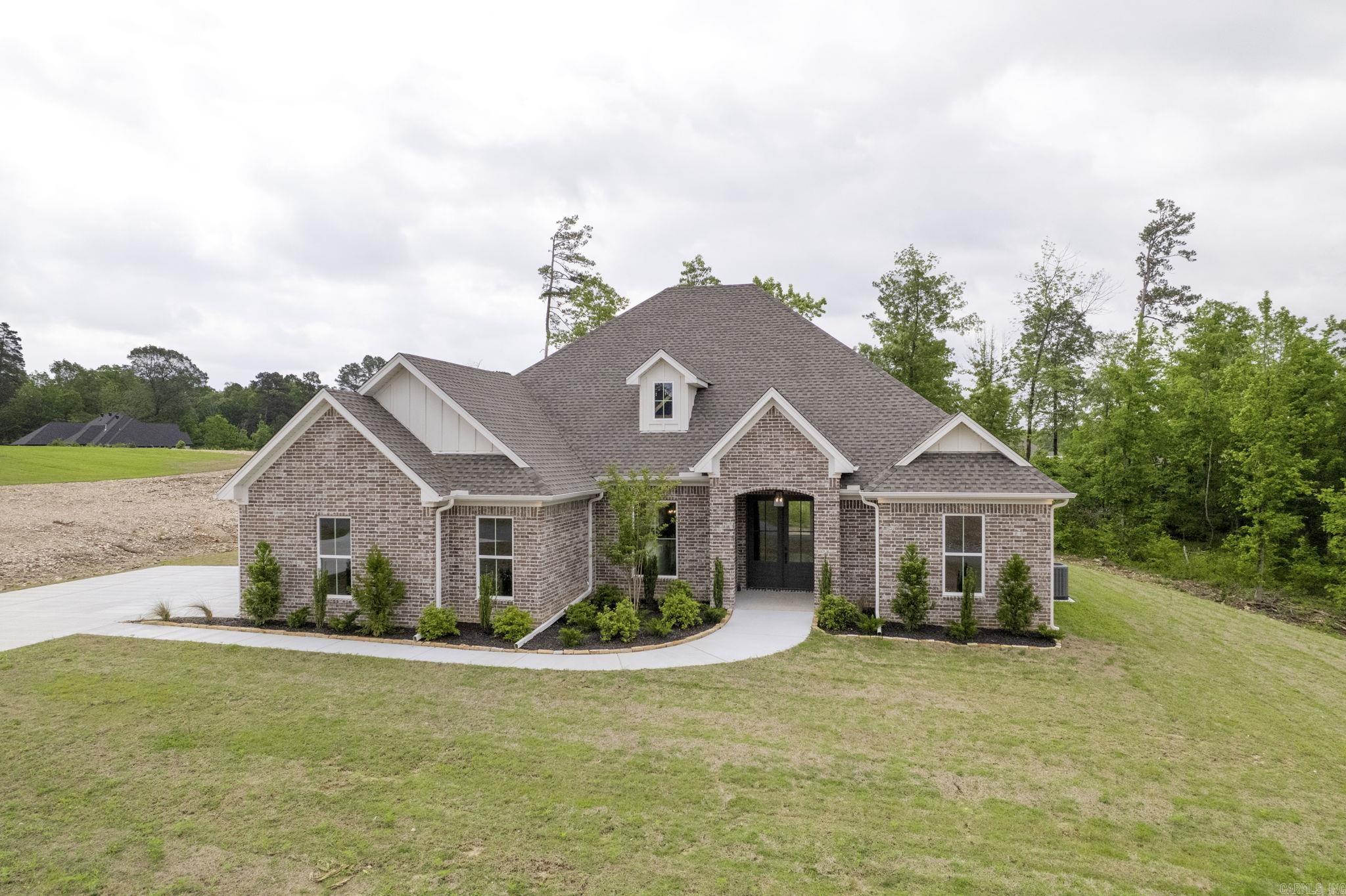 Welcome to this stunning 4-bedroom, 2-bathroom home nestled in the gated Charleston Place subdivision. Spanning 2,712 sq. ft. on just over an acre, this property offers the perfect blend of rural charm and modern convenience—giving you the peaceful country feel while being just minutes from town. Designed with a professionally curated color scheme, this home boasts an elegant and timeless aesthetic. The spacious lot provides plenty of room to add a shop or enjoy the open space. With privacy, security, and ample room to grow, this is a rare find in a sought-after community. Don't miss your chance to make this beautiful home yours!